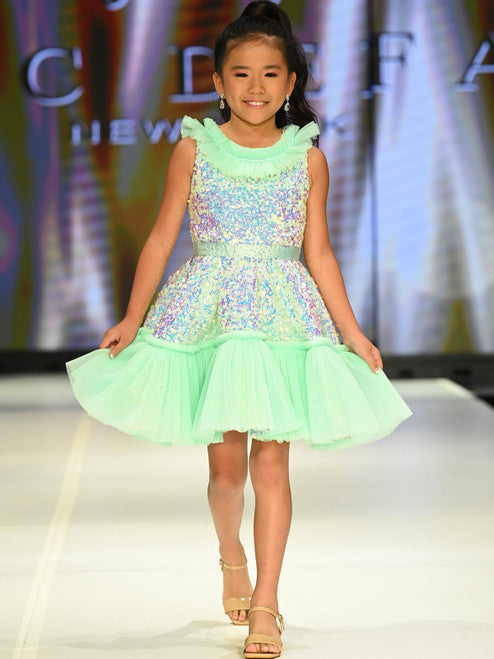 Marc Defang Kids 5111 Dress is a stunning cocktail dress for special occasions. Crafted from sequin tulle with pleated ruffle and layered detailing, it is sure to turn heads. Perfect for pageants, it will make your little one feel like a princess. Please inquire for additional colors.  Sizes: 4,5,6,7,8,9,10,11,12,13,14  Colors: Lilac, Mint, Royal Blue