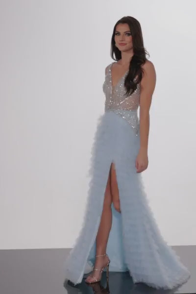 The Jovani 38912 is a breathtaking prom dress that belongs to the formal collection, perfect for making a lasting impression at your prom. This dress is crafted from tulle, a delicate and lightweight fabric that imparts a sense of whimsy and romance. The style of the dress is maxi, offering a floor-length hem that provides an elegant and graceful appearance. The layered skirt features a high slit, which adds a touch of drama and allure while allowing for easy movement. 