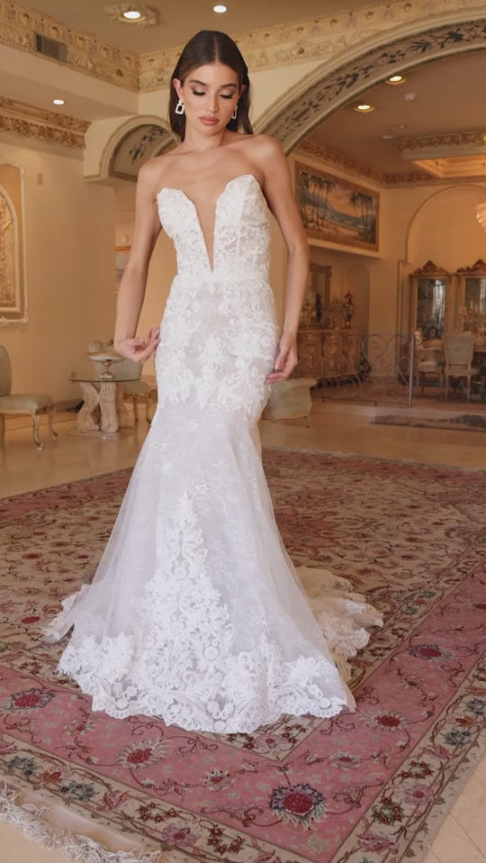 Look like a dream in the Ladivine CD928 long lace mermaid wedding dress. Featuring a stunning lacework that cinches the waist, corset bodice, and scallops at the hem, this gown creates an hourglass silhouette that is perfect for the special bride. The removable back tail allows for an elegant look during the ceremony and a more relaxed look for the reception. Make your wedding day extra special with the Ladivine CD928.