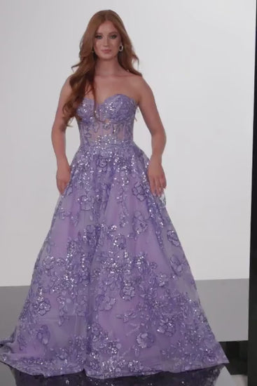 The Jovani 26223 is a breathtaking prom dress designed for the formal collection, perfect for making a stunning and memorable entrance at your special event. Crafted from delicate tulle, this gown exudes an ethereal and graceful quality, adding a touch of whimsy to your overall look.  In terms of style, the dress follows an A-line silhouette, offering a universally flattering and timeless appearance that complements various body types.