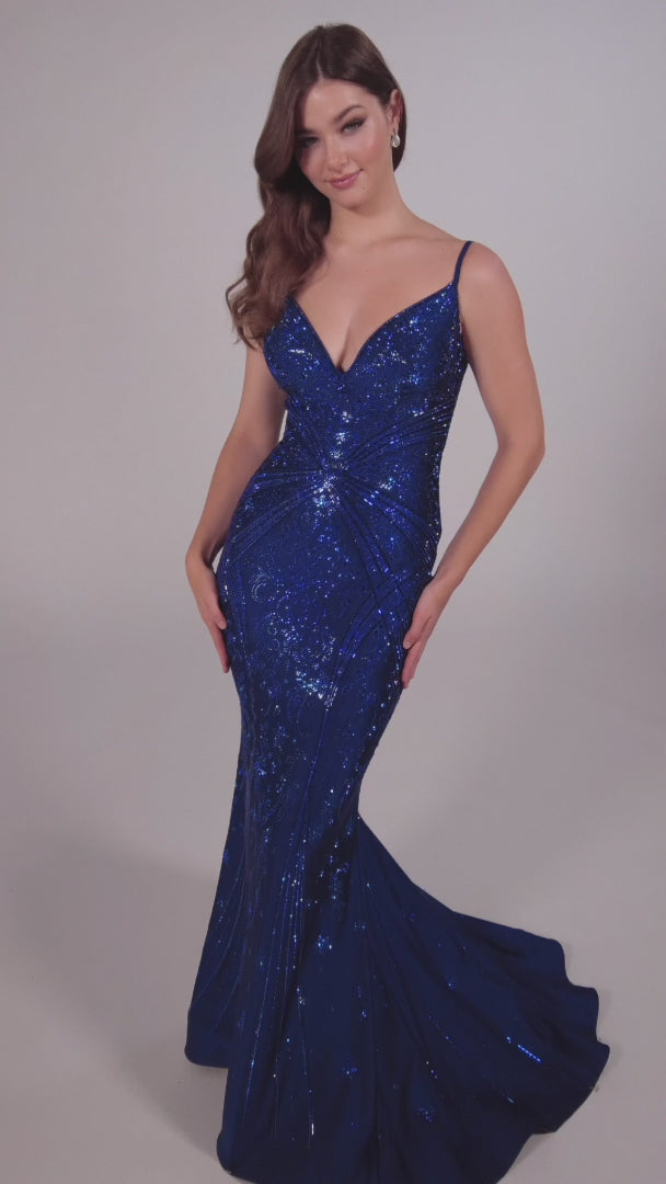 Look stunning in the Ellie Wilde EW35002 prom dress! Crafted from luxurious crystal jersey fabric, this mermaid evening gown features a corset-style bodice and a snug fit for a captivating silhouette. Decorated with shimmering Crystal accents, this dress adds sparkle and shine for an unforgettable formal look.  COLOR: BLACK, NAVY BLUE, ROYAL BLUE, TEAL, HOT PINK, RUBY, ORCHID SIZE: 00 - 24