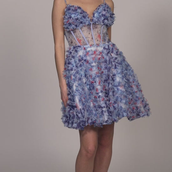 This Dave &amp; Johnny 11768 Short Ruffle Floral Homecoming Dress blends a charming floral print with a sheer corset top for a unique and stylish look. The A-line silhouette is flattering and comfortable, making it perfect for any cocktail occasion. Upgrade your wardrobe with this beautiful and fashion-forward gown.