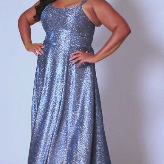 This plus-sized prom dress from Sydney's Closet SC7349 is made of shimmering knit and features an A-line silhouette, scoop neckline, double straps, zip-up back, natural waist, A-line skirt with slit, and hidden pockets. Fully lined for a comfortable and flattering fit. Perfect for special occasions. Keep it sweet and sparkly when you wear our classic A-line plus size prom dress! 