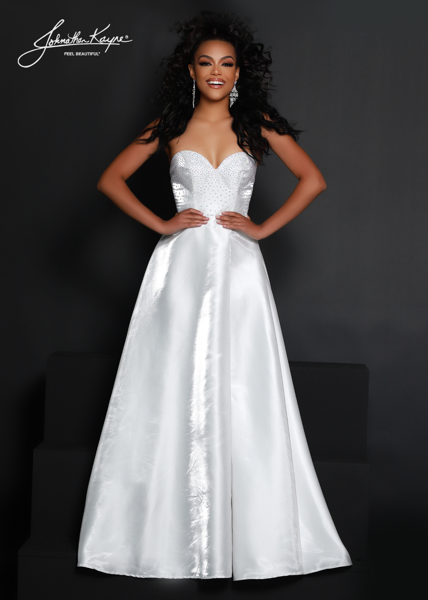 Make a statement in this Johnathan Kayne 2642 dress! Made of luxurious White Shimmer satin, its A-line silhouette and puff sleeves will have you looking fabulous for any formal occasion. With a high slit for extra pizzazz, you won't be able to resist this elegant maxi dress! Shake things up in style! Show off your style and sophistication in this beautiful shimmer satin A-line gown with removeable puff sleeves at any event  Size: 2  Color: White