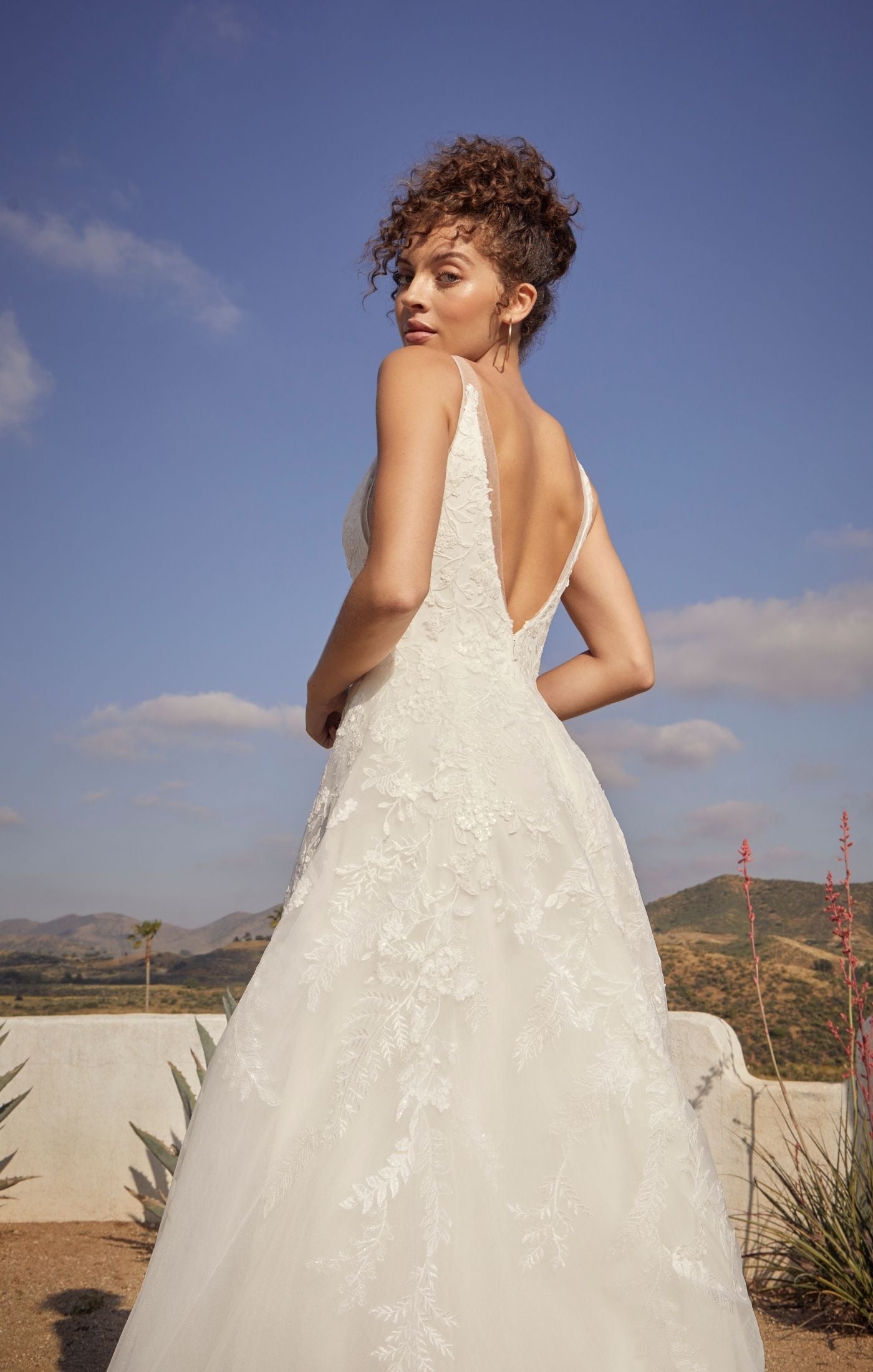 Casablanca Beloved BL431 Janie A-Line Ballgown V-Neck Floral Lace Train Wedding Gown. Reminiscent of storybook romance, exceptionally sweet Style BL431 Janie is a treasure to behold. Crafted with meticulous attention to detail, Janie features a delicate lining that ensures a comfortable fit, allowing you to move with ease. The combination of organza, tulle with floral lace, and sequins creates a breathtaking effect, adding depth and dimension to the gown