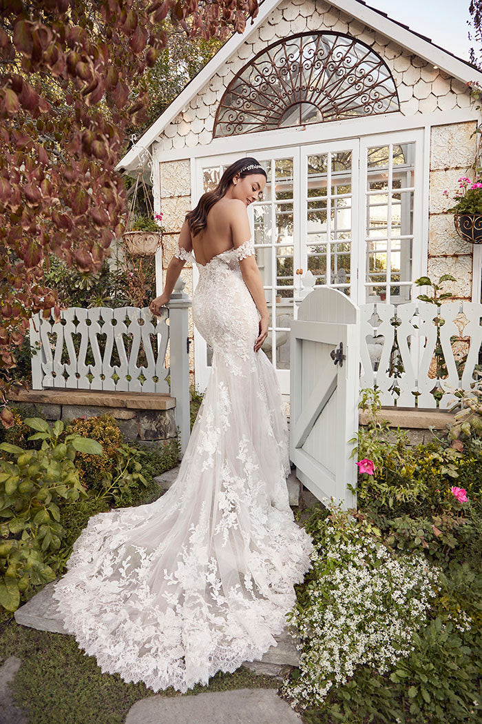 Elegant and ethereal, Style 2491 Palmer by Casablanca radiates feminine romance. Detachable off-the-shoulder sleeves connect to a strapless plunging neckline for a wedding day style as vibrant as it is versatile. Stretch lining and Chantilly lace complement your natural curves in this fit-and-flare gown with 60" train. Rich in floral appliqués, delicate beading, and sequins, Palmer exudes subtle shimmer with every step. Pair with a long, dramatic, flowing 125" cathedral veil to complete the look.