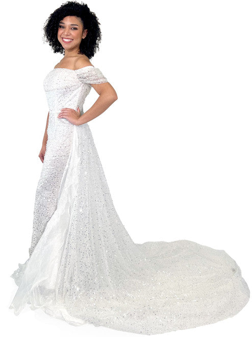 This Marc Defang 8228 dress is an elegant, fitted off-the-shoulder design, featuring a detachable overskirt and ornate pearl, sequin, and beaded detailing. It's perfect for a unique prom, pageant, or wedding look. Corset back  Sizes: 00-16  Colors: Hot Pink, White  *Allow 30 days production