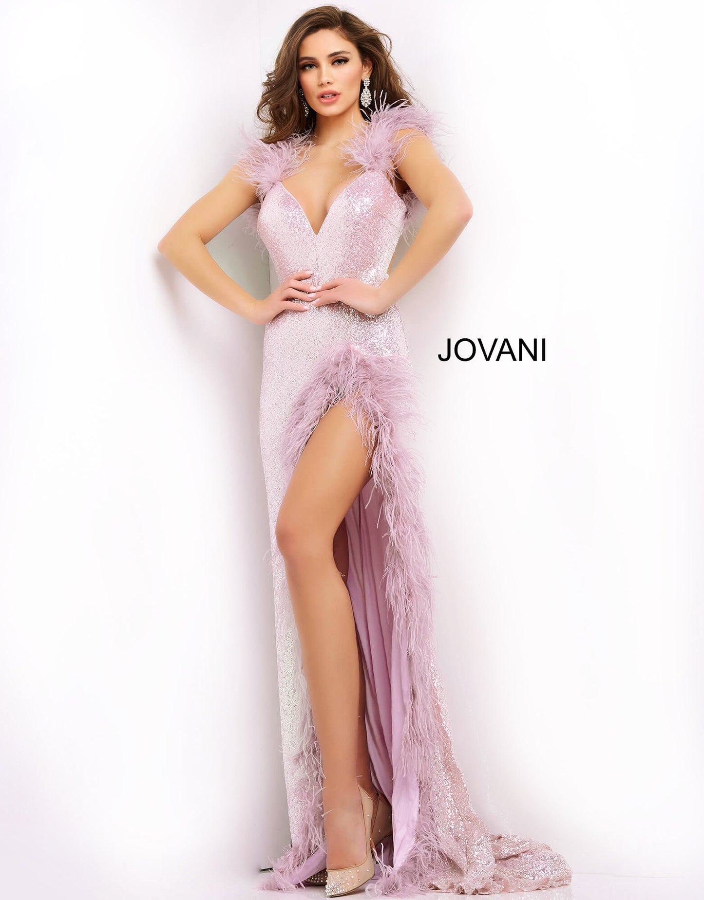 Jovani 06164 This extravagant Prom, Pageant and Evening Gown has a Plunging neckline with feather details on the straps and surrounding the high thigh side slit.  The long prom dress has sequins throughout and has a sexy open back.   Colors  Cream, Lilac  Sizes  00-24