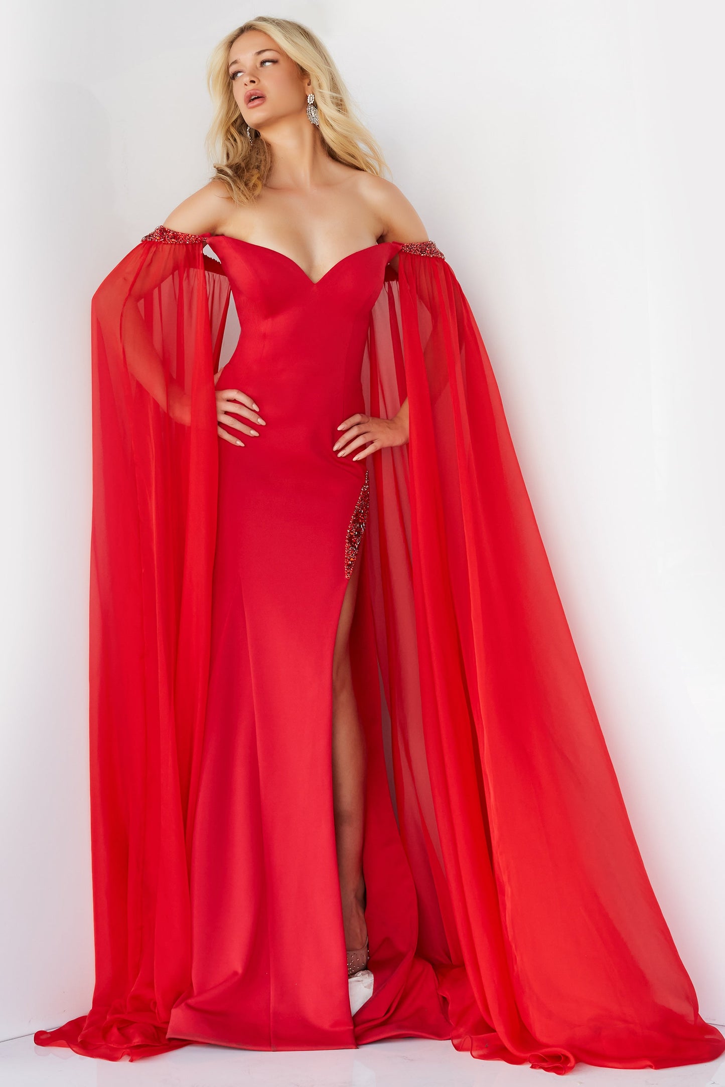 Jovani 07652 Prom Dress Cape Sleeves Pageant Gown.  This is a strapless prom dress with flattering fitted silhouette with an off-the-shoulder sweetheart neckline. It has  beaded chiffon around the arms with long sheer sweeping chiffon Cape Sleeves.  Excellent choice for Pageants.