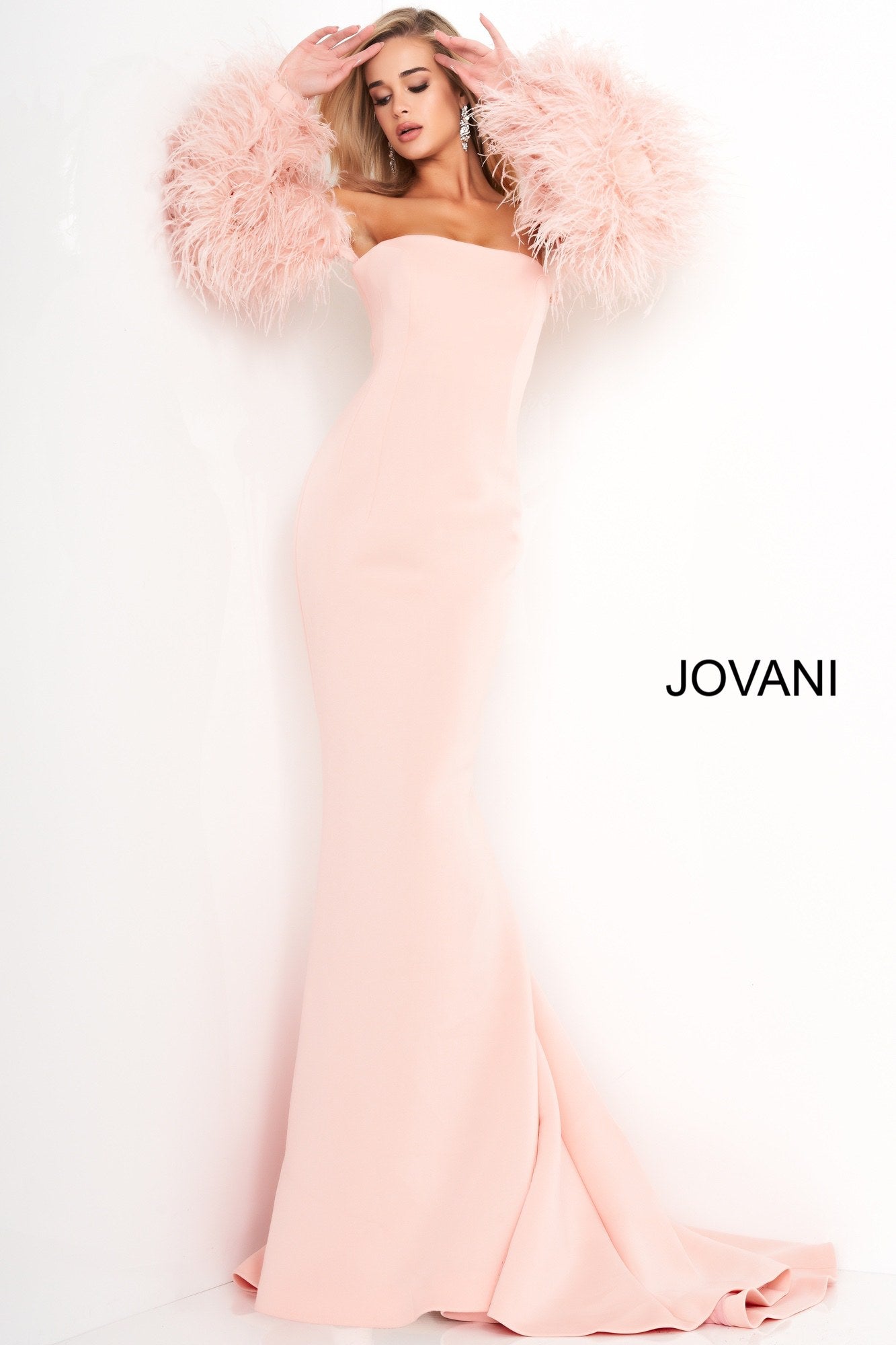 Jovani 1226 is a Long Fitted Mermaid Scuba Formal Evening Gown. This Straight neckline with Long Off the Shoulder Feather Sleeves. This Fit & Flare Wedding Dress Features a Lush Sweeping train. Great Red Carpet or formal event gown. Great for a wedding guest dress or mother of the bride gown. Stretch scuba fabric, form fitting silhouette, floor length with train, strapless bodice, straight neckline, ostrich feather sleeves. Available Sizes: 00-24  Available Colors: black, blush, white, white/black