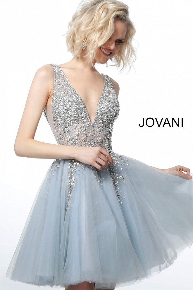 Jovani 1774 Tulle Sheer V-Neck Embellished Bodice Short Cocktail Homecoming Dress. Make a statement at your event with the Jovani 1774 White Fit and Flare Tulle Homecoming Dress. This stunning dress features a fitted bodice with intricate beading and a flared tulle skirt, creating a breathtaking and eye-catching silhouette. With its elegant design and high-quality construction, this dress will make you the center of attention on any special occasion.