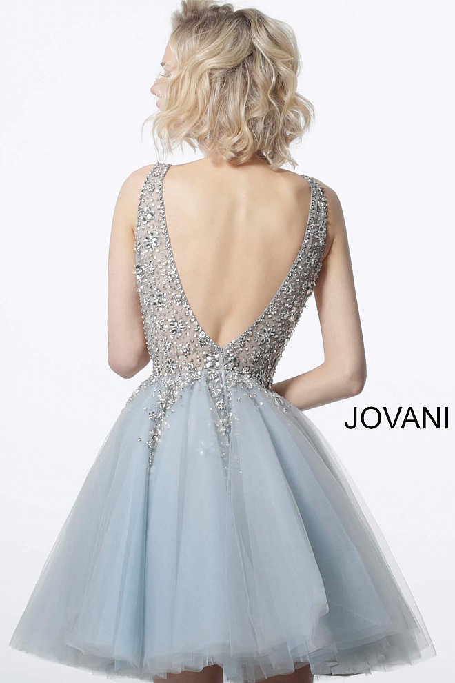 Jovani 1774 Tulle Sheer V-Neck Embellished Bodice Short Cocktail Homecoming Dress. Make a statement at your event with the Jovani 1774 White Fit and Flare Tulle Homecoming Dress. This stunning dress features a fitted bodice with intricate beading and a flared tulle skirt, creating a breathtaking and eye-catching silhouette. With its elegant design and high-quality construction, this dress will make you the center of attention on any special occasion.