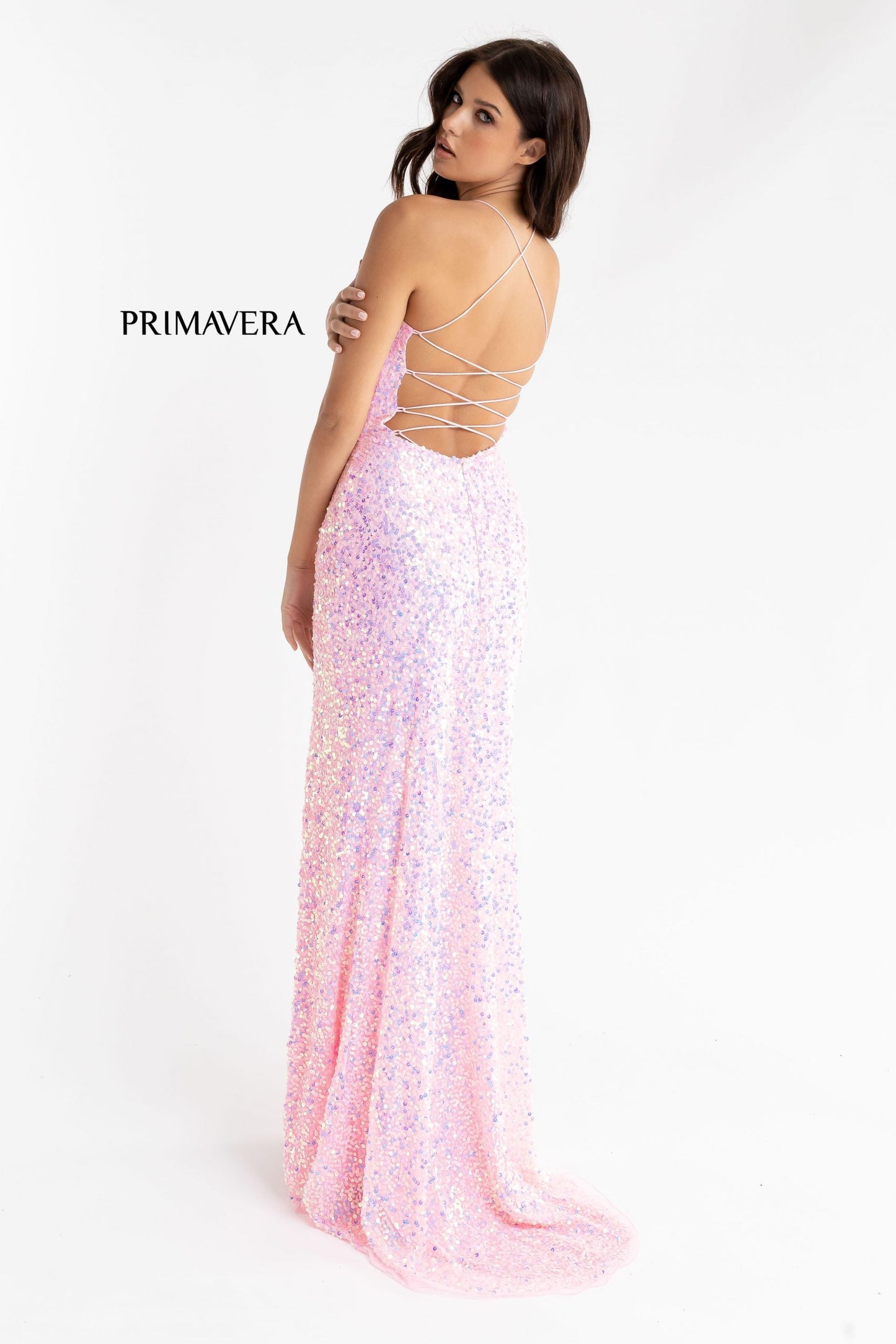 Primavera Couture 3290 This prom dress adds a pop to the multi sequins dress.  With a scoop neckline and spaghetti straps that cross and tie in the back.  This long evening dress has a side slit. 