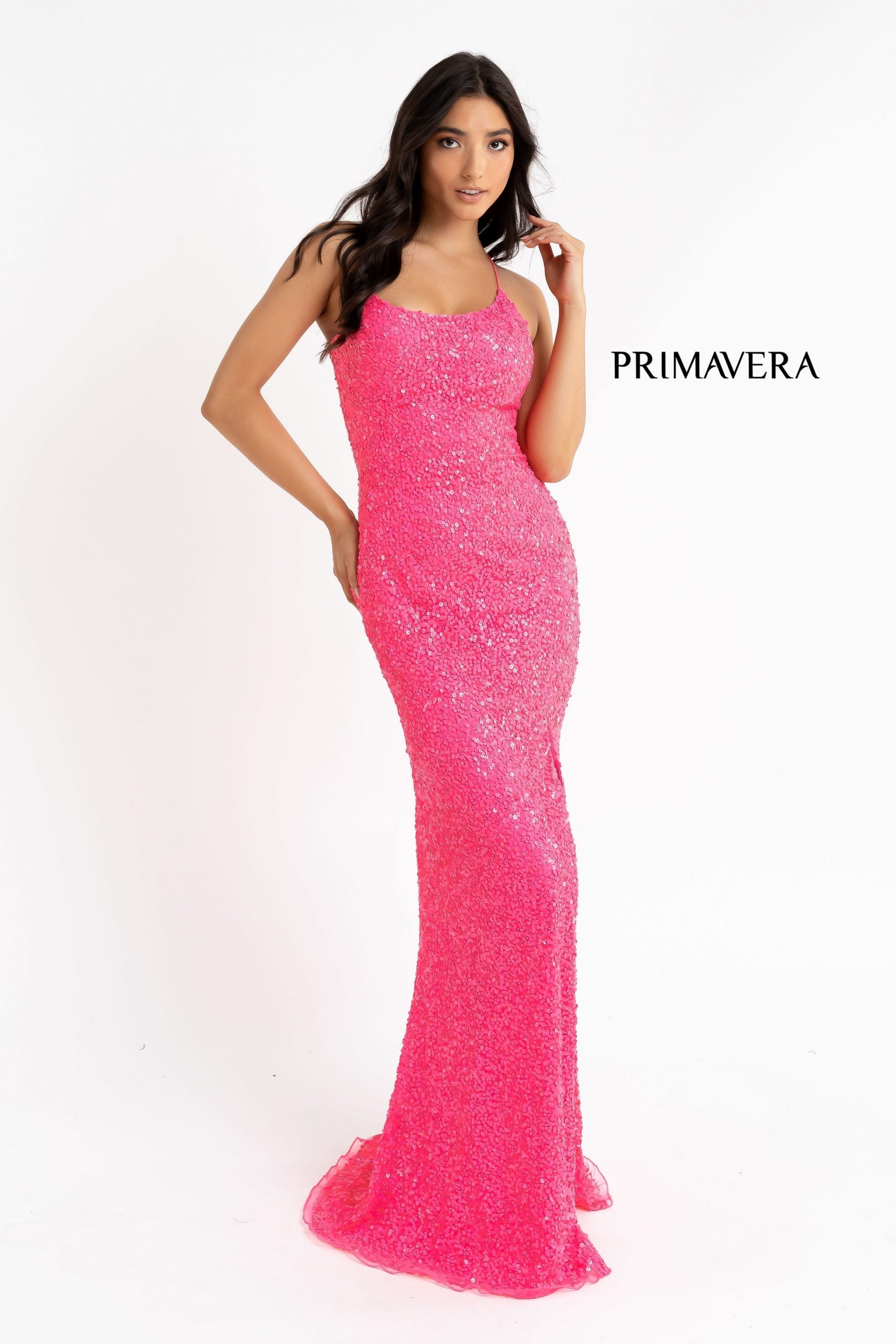 Primavera Couture 3290 This prom dress adds a pop to the multi sequins dress.  With a scoop neckline and spaghetti straps that cross and tie in the back.  This long evening dress has a side slit. 