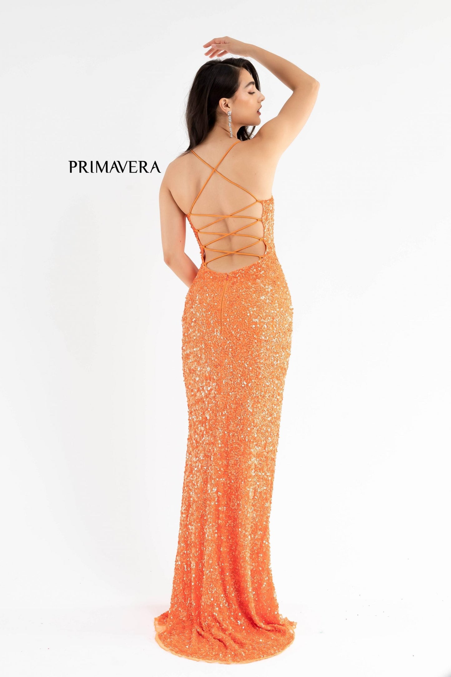 Primavera Couture 3290 This prom dress adds a pop to the multi sequins dress.  With a scoop neckline and spaghetti straps that cross and tie in the back.  This long evening dress has a side slit. 