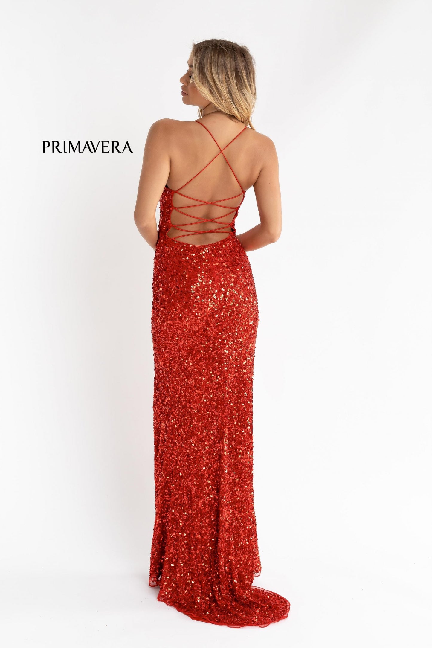 Primavera Couture 3290 This prom dress adds a pop to the multi sequins dress.  With a scoop neckline and spaghetti straps that cross and tie in the back.  This long evening dress has a side slit. 