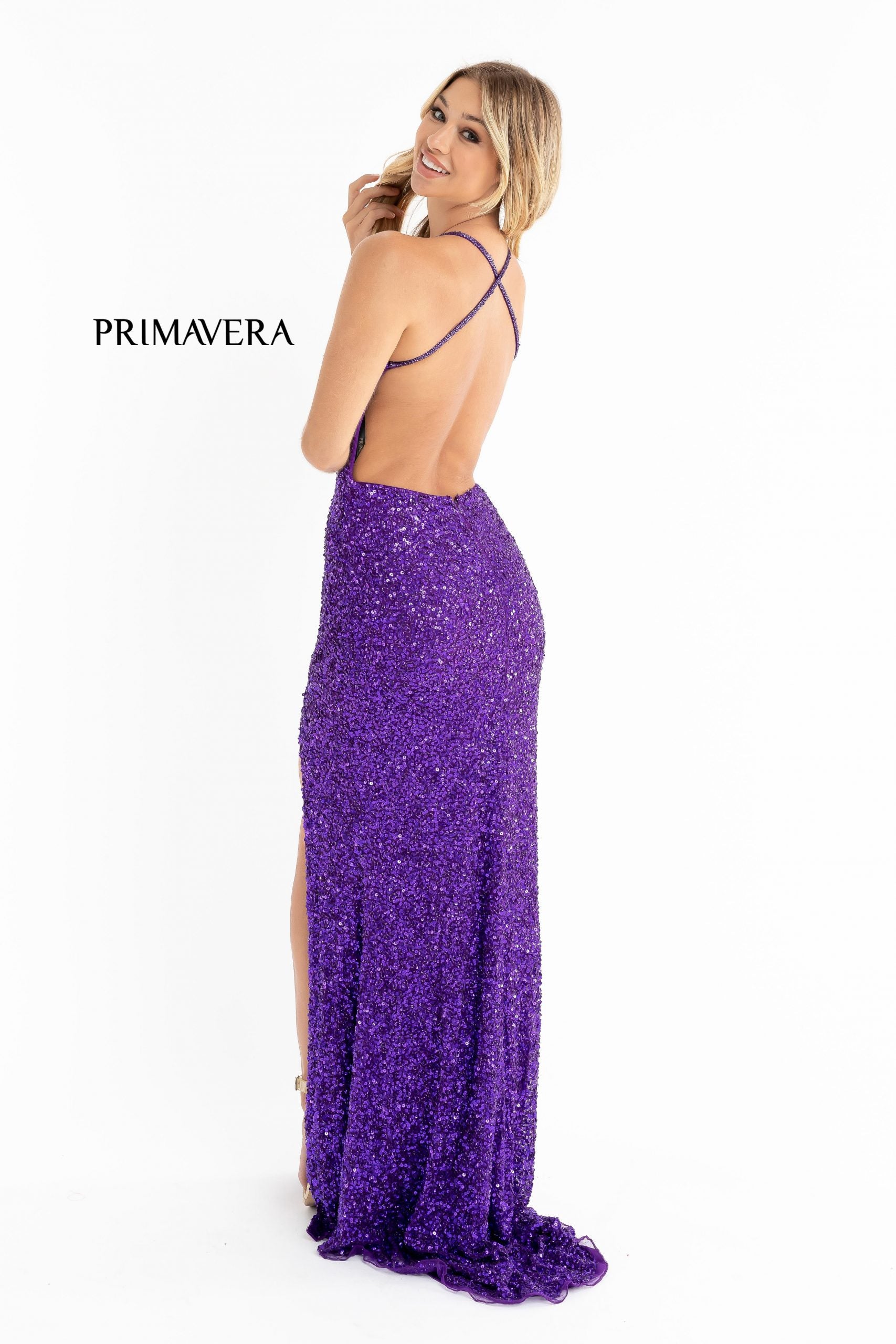 Primavera Couture 3291 Exclusive Prom Dresses.  This long prom dress is embellished throughout with shimmering sequins.  This impressive gown showcases a v neckline, thin beaded straps and crisscrossed straps in the open back. The long slim skirt has a sultry high side front slit. 