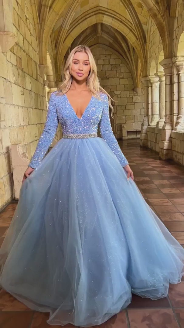 Ava Presley 38332 Long Sleeve Velvet Sequin Bodice with a V Neckline. Glitter Shimmer A Line Ballgown skirt with a crystal rhinestone waistband. full modest back coverage. Prom Dress Pageant Gown.  Sizes: 00-24  Colors: Royal, Red, Iridescent White, Iridescent Pink, Iridescent Light Blue