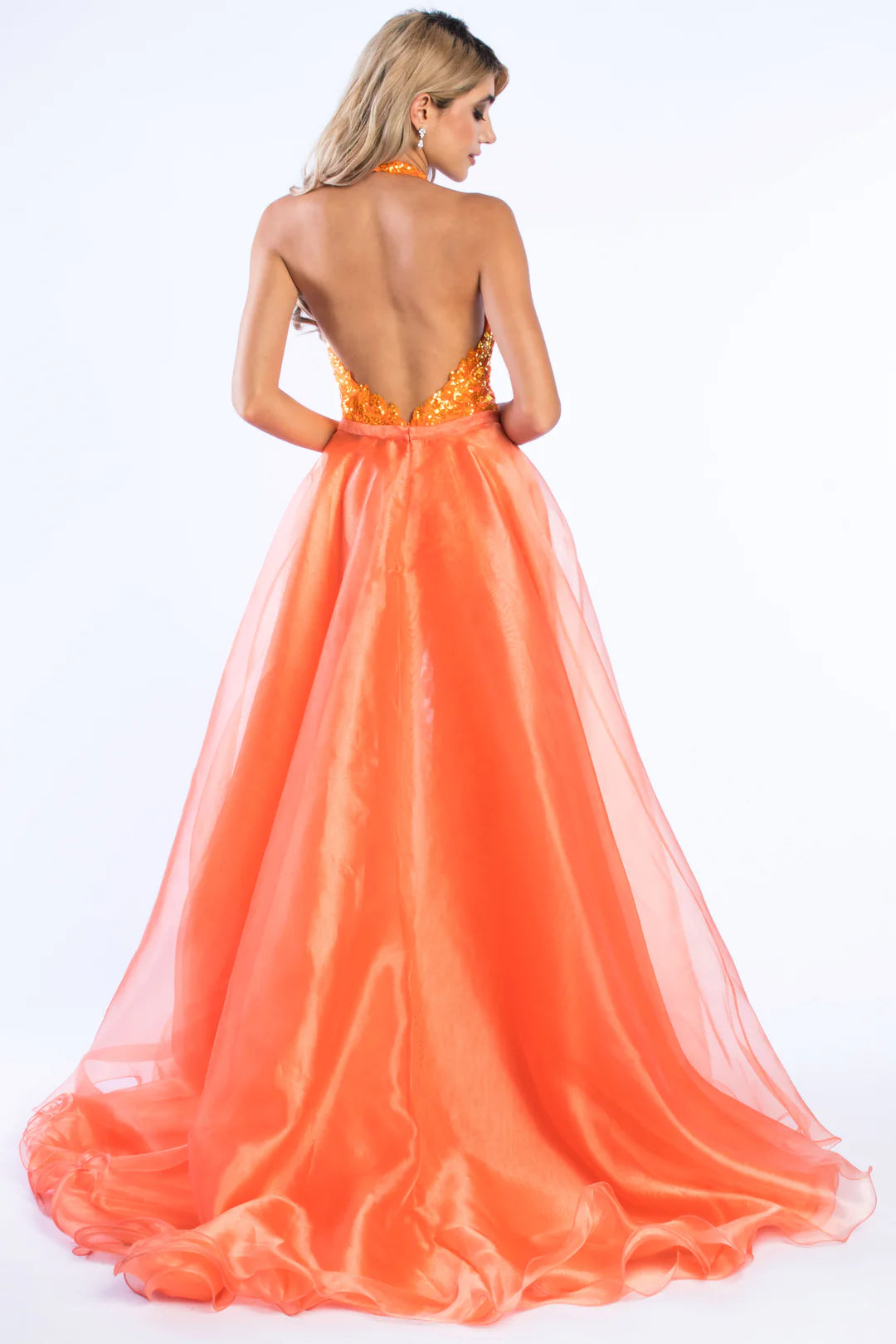 Ava Presley 37381 is crafted with a long, sheer sequin halter jumpsuit, detachable overskirt, V-neck backless design, and a hint of fun fashion. The result is a luxurious, glamorous look perfect for pageants.  Sizes: 0-16  Colors: Royal, Fuchsia, Iridescent Orange