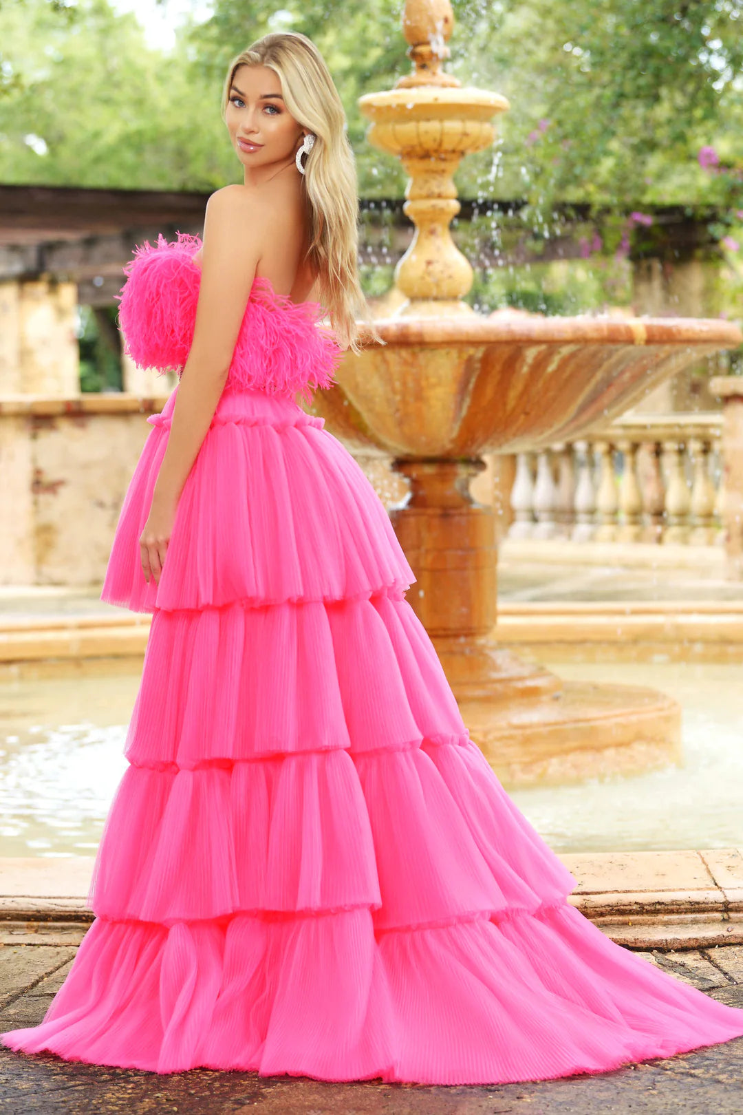 Make a statement in the stunning Ava Presley 38882 Prom Dress. This eye-catching piece features a high-low silhouette adorned with ruffle layered pleats, ruffles at the neck, and feathers. Enchanting and elegant, it's a perfect choice for prom, formal or pageant events. Strapless Feather Bodice with a rhinestone & beaded waist belt.  Sizes: 00-18  Colors: Red, Hot Pink