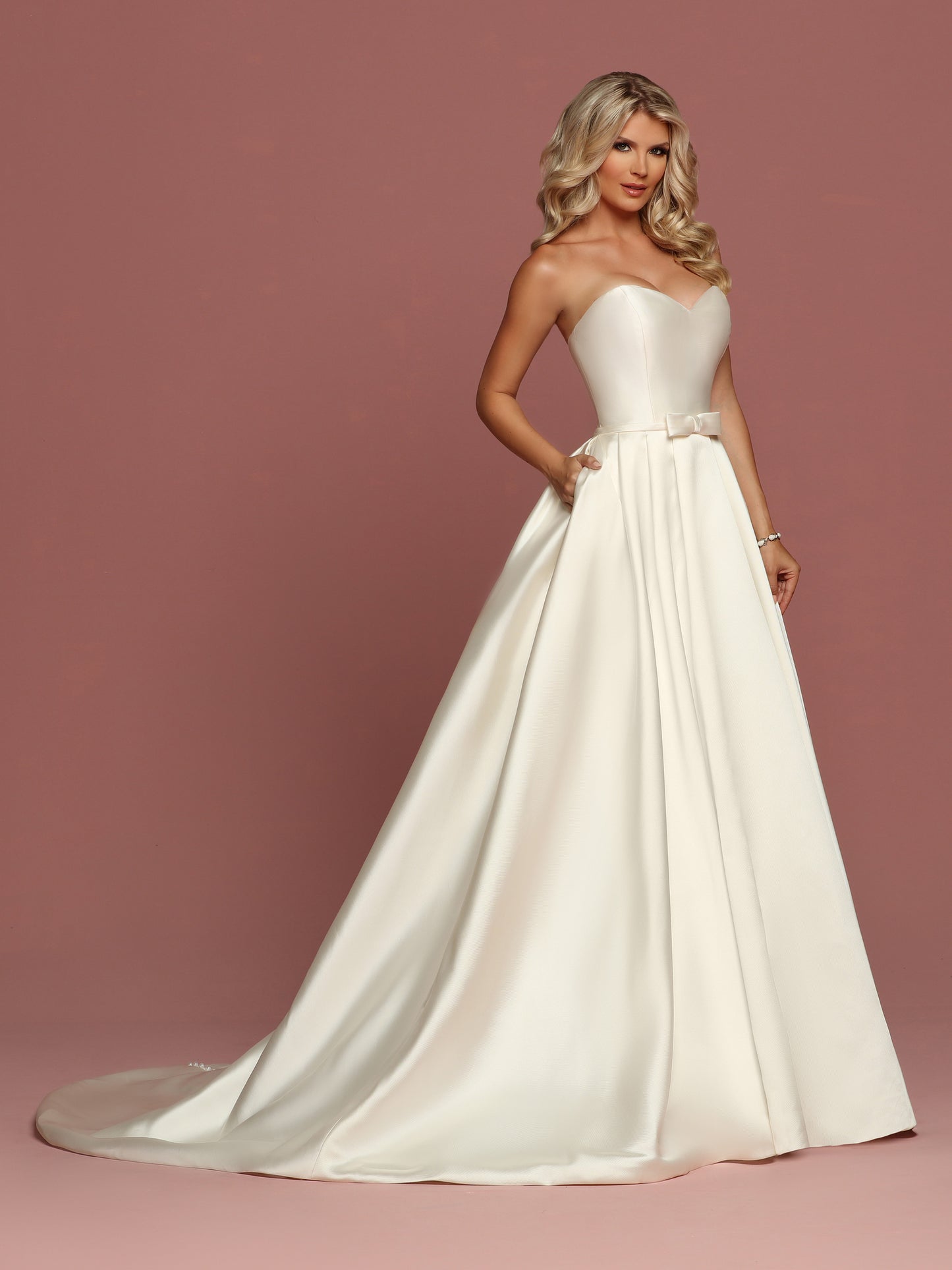 Davinci Bridal 50494 is a gorgeous Mikado Wedding Dress. Strapless Sweetheart neckline with a simple waist belt with bow. Full Pleated skirt has Pockets! Button line the entire back seam of the gown into the train.  Available for 1-2 Week Delivery!!!  Available Sizes: 2,4,6,8,10,12,14,16,18,20  Available Colors: Ivory