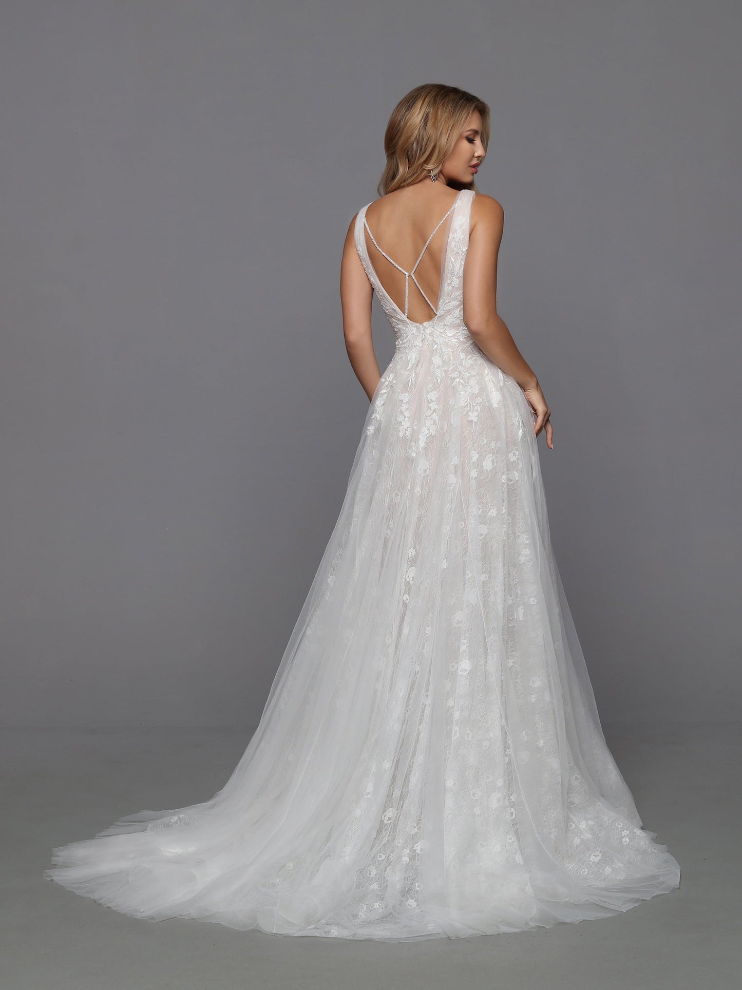 The focal point of this tulle and lace A-Line wedding dress is the open back. Criss-cross beaded straps highlight the shoulder blades and lead the eye to the softly flowing, gathered tulle skirt and chapel train. Davinci Bridal 50760 Beaded Sequin Lace A Line Wedding Dress V Neck Bridal Gown 