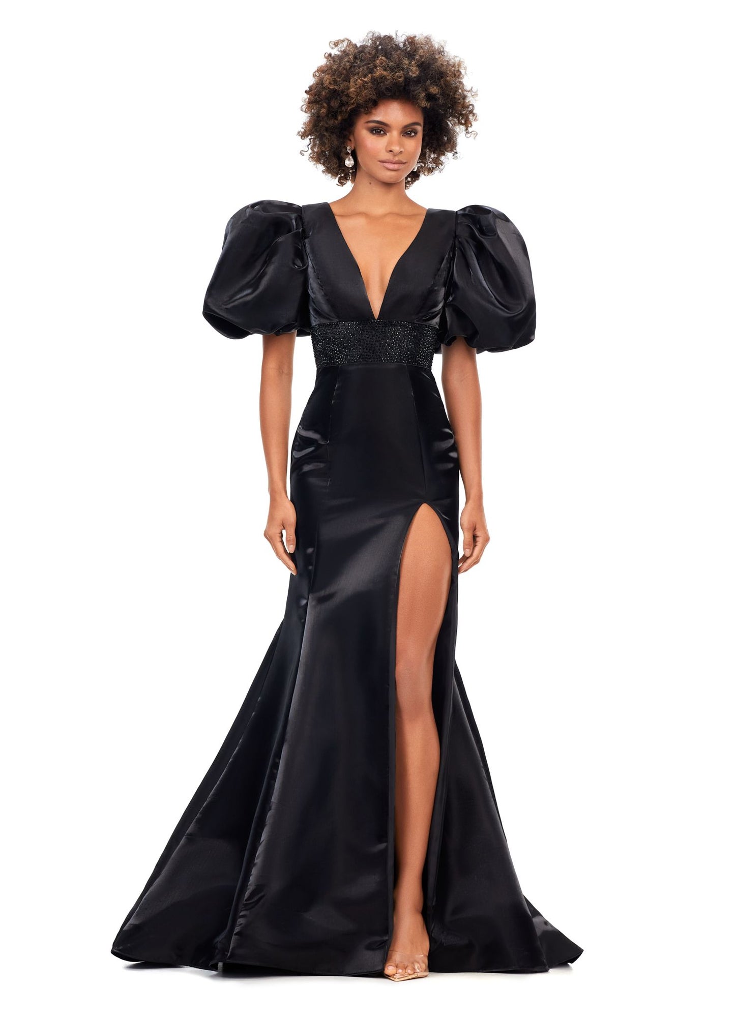 Ashley Lauren 11379 Shine in this v-neckline dress that features oversized puff sleeves. The waistband is embellished with scattered heat set stones and is complete with a lace-up back. V-Neckline Oversized Puff Sleeves Fitted Skirt Shimmer Satin COLORS: Aqua, Black, Red