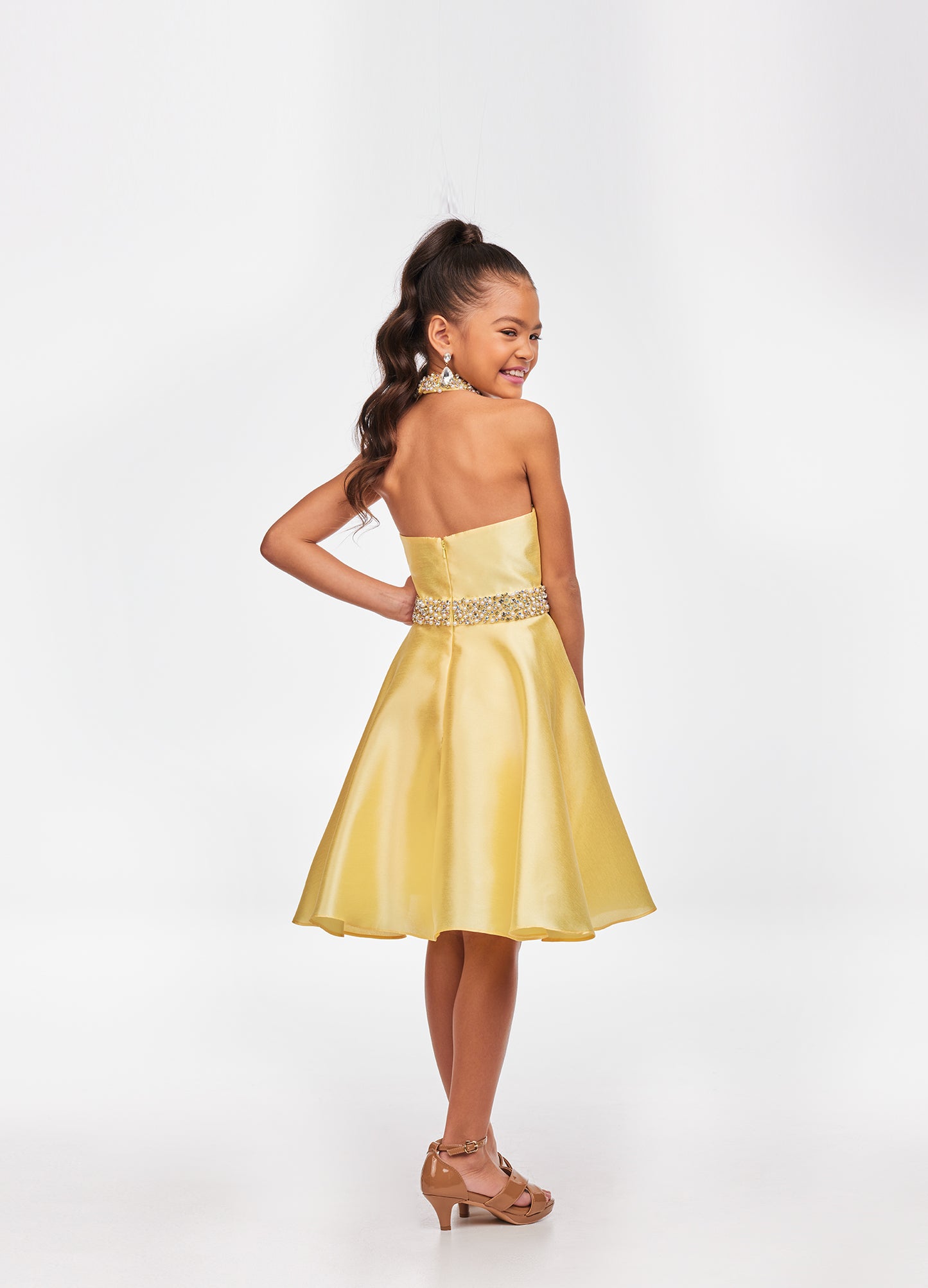 Ashley Lauren Kids 8103 Short Halter cocktail dress with overskirt Pageant Wear Stunning kids mikado cocktail dress featuring a crystal and pearl neckline and waist. The slight a-line skirt is completed with an overskirt for extra flare. Halter Neckline Crystal Beaded Neck & Belt A-Line Skirt Overlay Available Sizes: 4-16 Available Colors: Sky, White, Yellow, Orchid