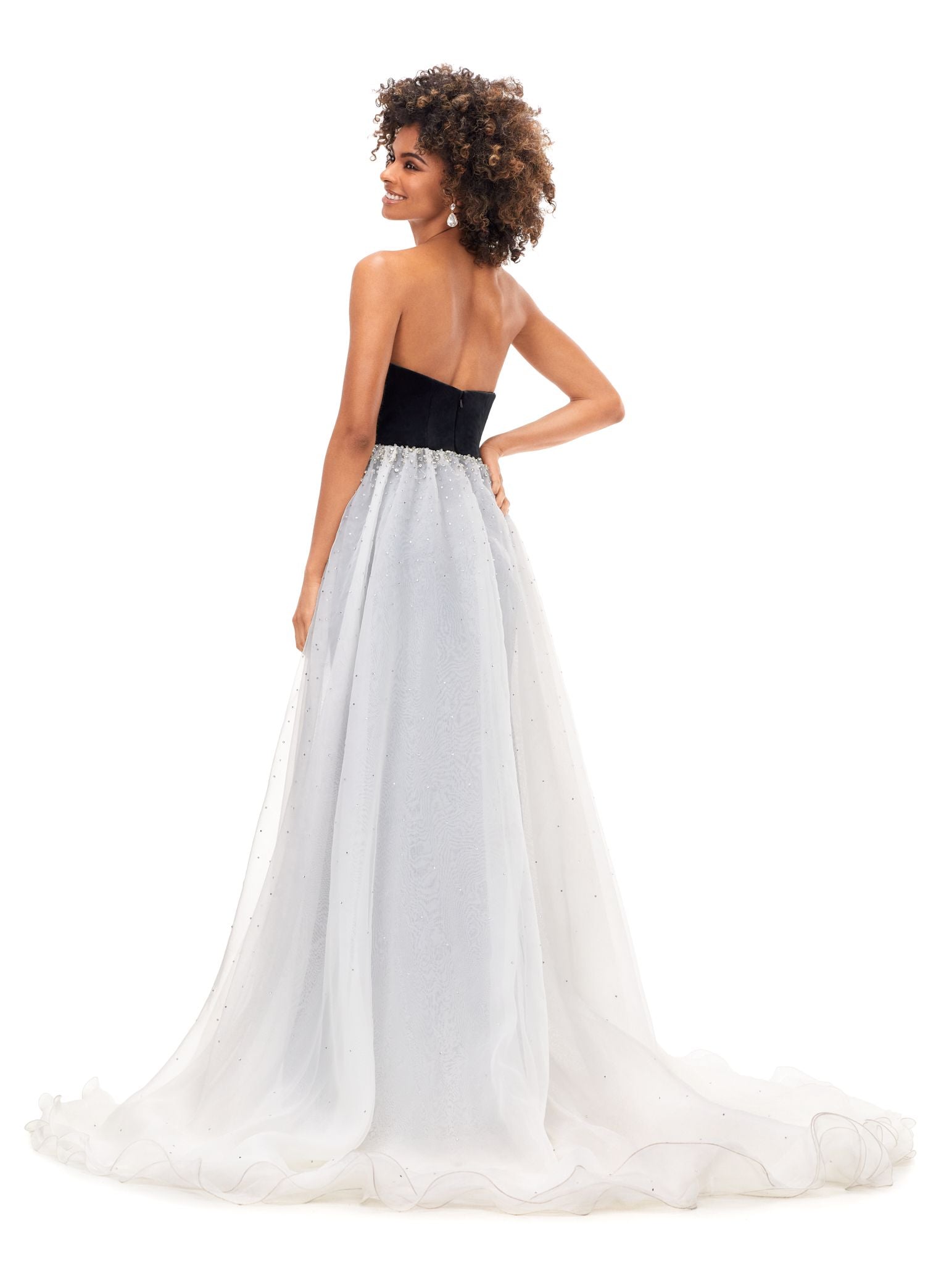 Ashley Lauren 11311 This stunning velvet gown features a sweetheart neckline with an organza overskirt. The overskirt is embellished with scattered crystals that cascade down the skirt. Strapless Bustier Crystal Details Stretch Velvet Organza Overskirt COLORS: Navy/Sky, Black/Ivory