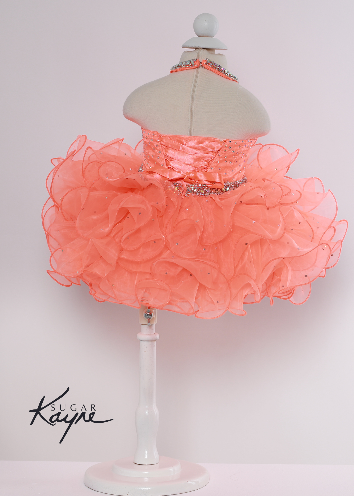 Sugar Kayne C220 Girls Baby Halter Cupcake Ruffle Pageant Dress Corset Formal Gown Have your little cupcake bring on all the charm in this stunning organza gown. The corset back is the perfect addition as the little one grows!  Colors: Bubblegum, Neon Orange, White  Sizes: 0M, 12M, 18M, 24M, 2T, 3T, 4T, 5T, 6M, 6T  Fabric Organza, Satin Lining