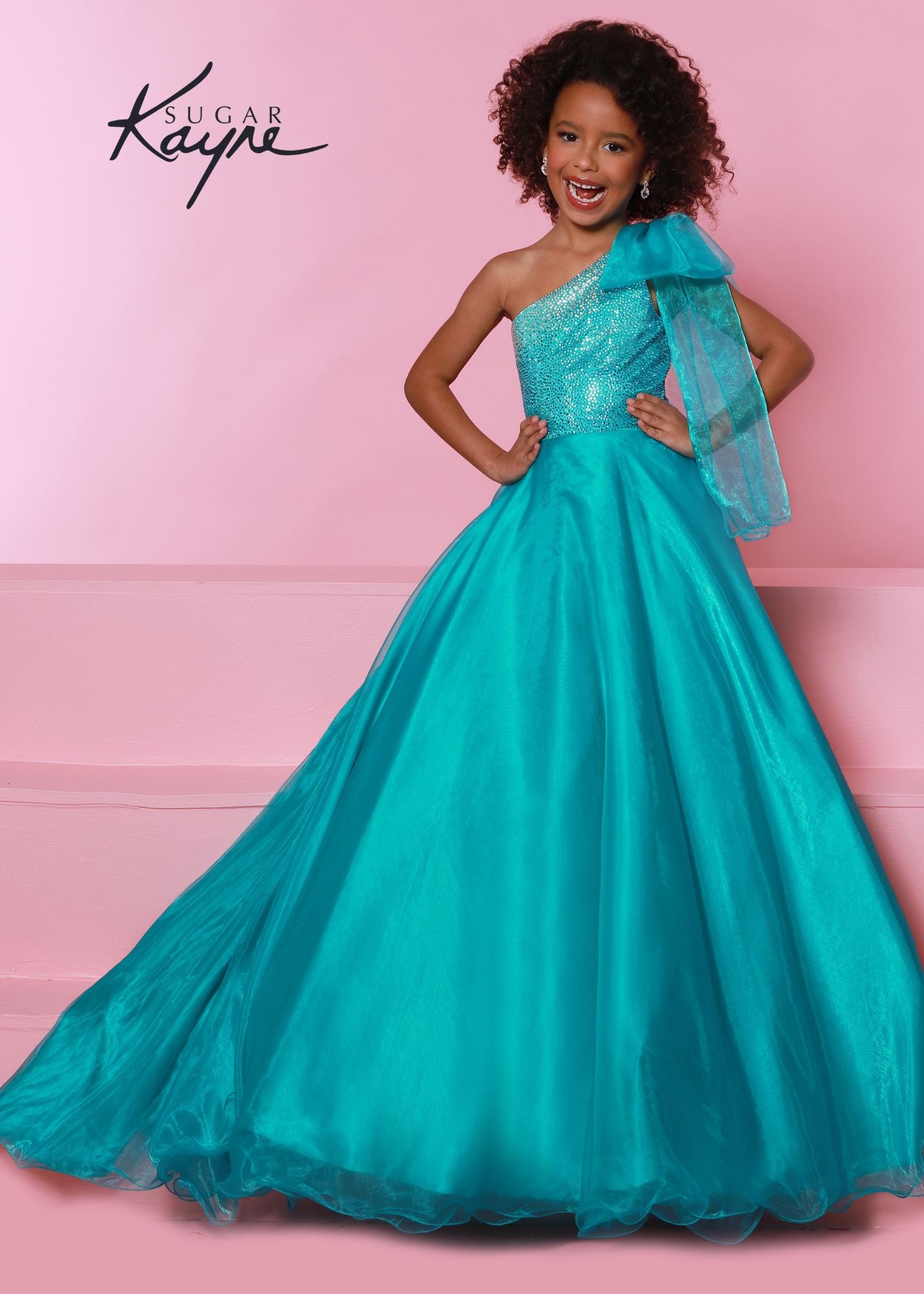 Sugar Kayne C310 Girls One Shoulder Bow A Line Shimmer Pageant Dress Crystal Gown  Go ahead and take a BOW in this lovely one-shoulder organza ballgown. The ombre beaded bodice brings all the dazzle!  Colors: Orange, Yellow, Blue  Sizes: 2, 4, 6, 8, 10, 12, 14, 16  Fabric Organza, Mesh, Satin Lining