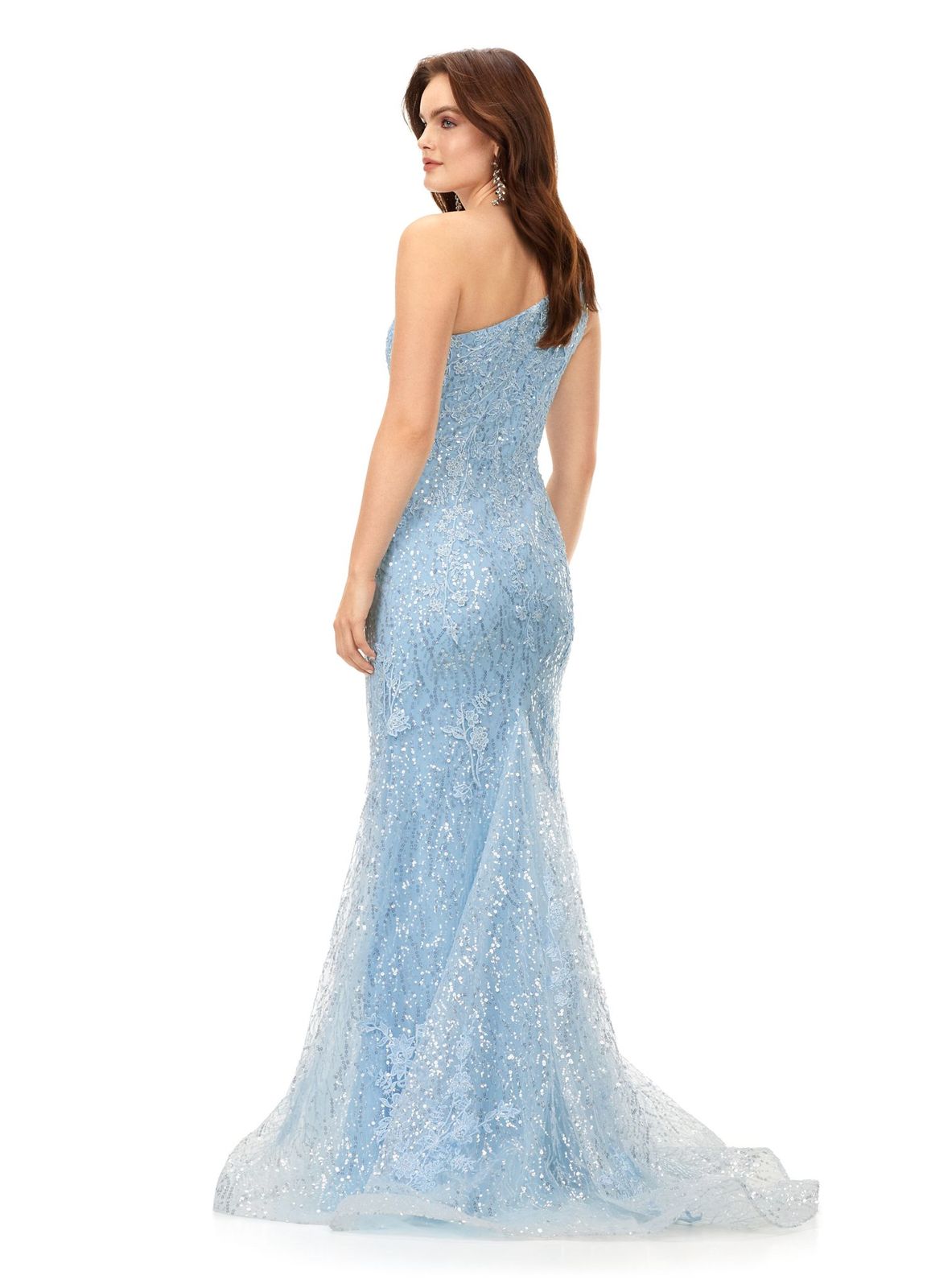 Ashley Lauren 11334 Feel ultra glamourous in this one shouldersequin gown. The bodice is embellished with lace appliques that cascade down onto the fitted skirt. The look is complete with a full zipper back. One Shoulder Fitted Skirt Sequin Applique Sweep Train COLORS: Sky, Lilac