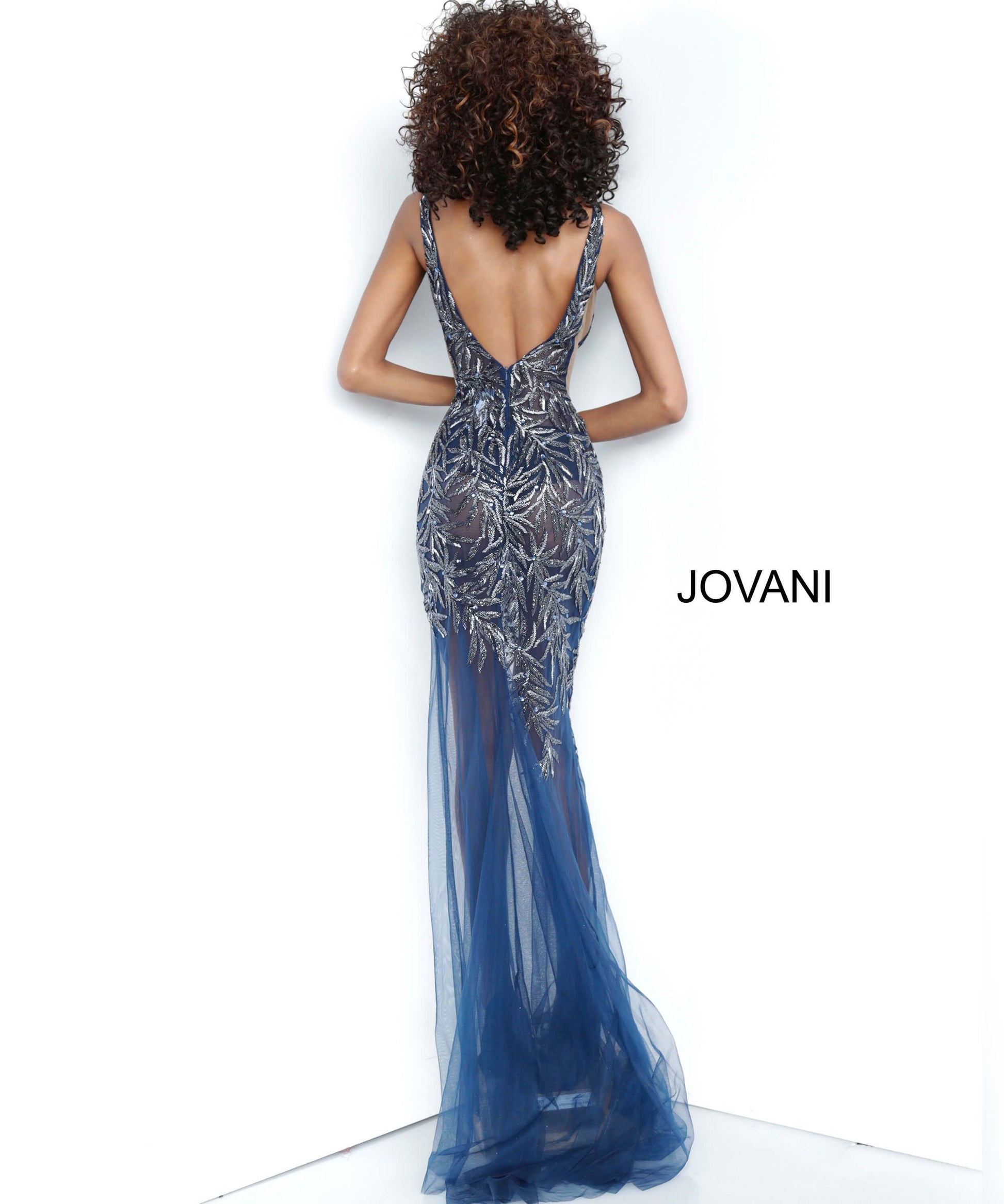 Jovani 1863 is a Gorgeous sheer Fully embellished Plunging Deep v neckline prom dress & Formal evening gown with slit in the sheer column skirt. Fully Embellished Crystal accented beaded sheer fitted bodice. Sheer side panels with mesh inserts.   Available colors:  Navy, Red, Silver/Nude, White  Available sizes:  00-24 