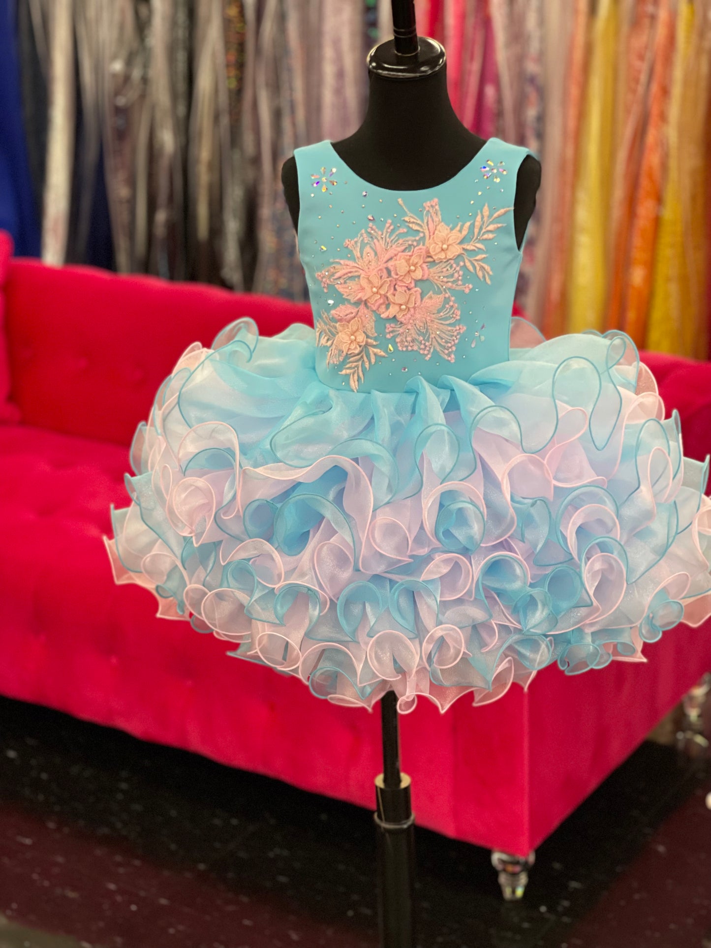 Marc Defang 5117K size 8 Turquoise girls cupcake pageant dress with pink applique on the top with crystal scattered throughout.  Multi blue and pink ruffle skirt.  Size 8  Color: Turquoise