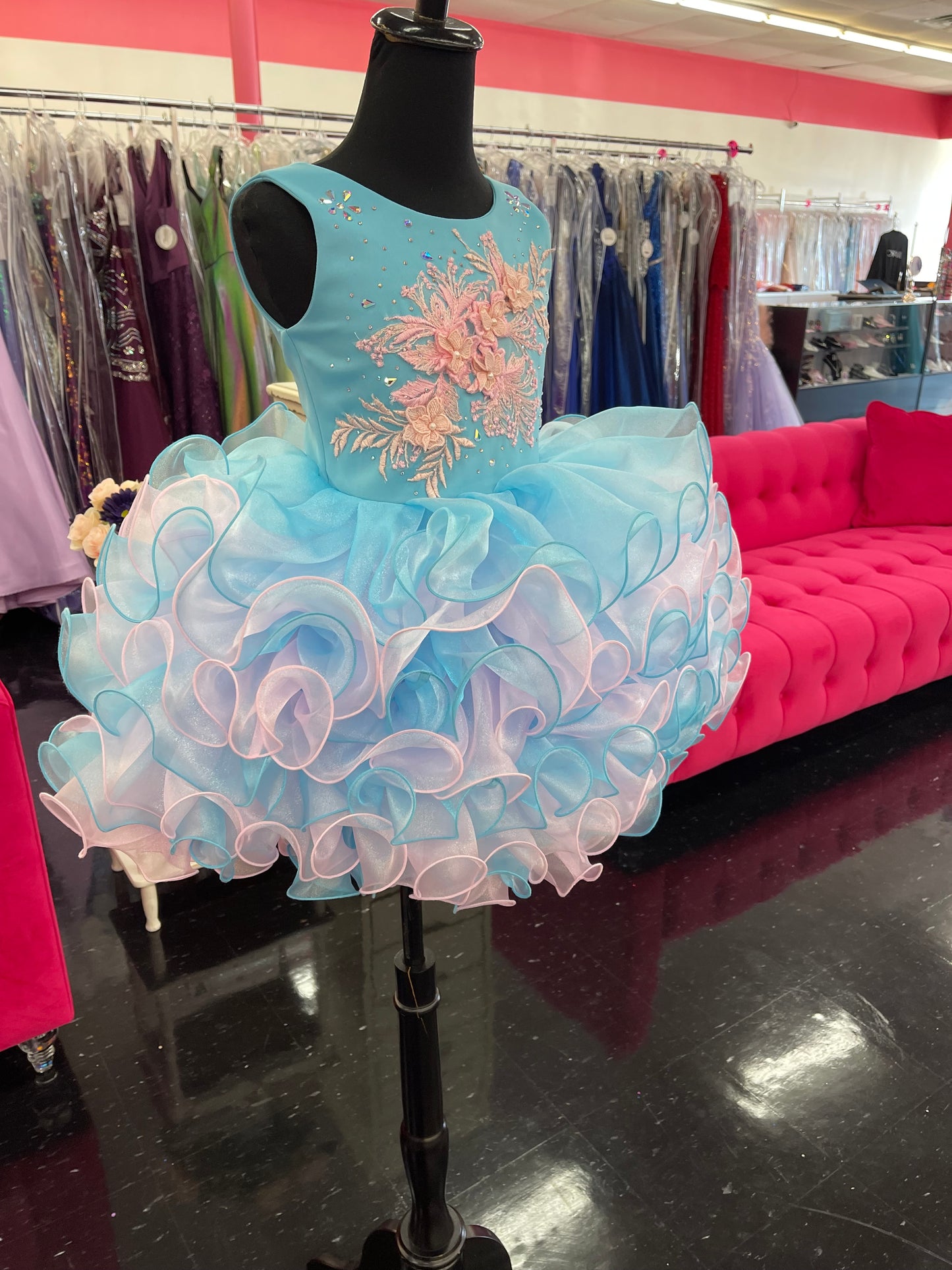 Marc Defang 5117K size 8 Turquoise girls cupcake pageant dress with pink applique on the top with crystal scattered throughout.  Multi blue and pink ruffle skirt.  Size 8  Color: Turquoise