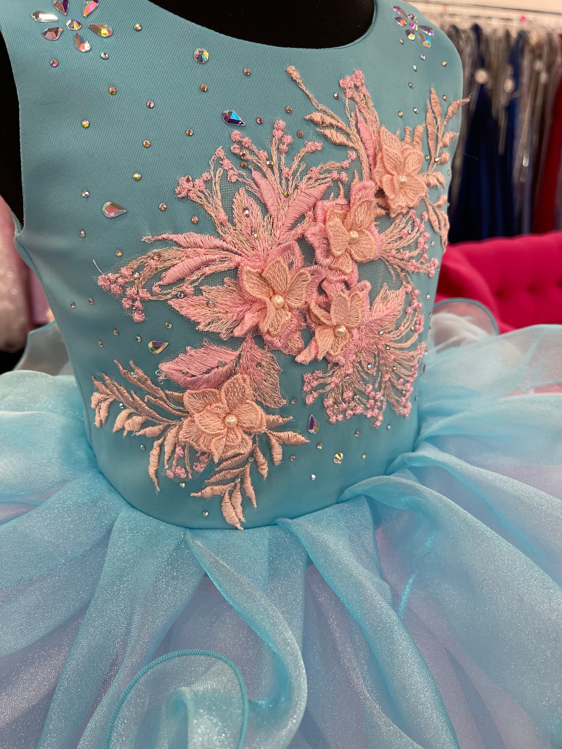 Marc Defang 5117K size 8 Turquoise girls cupcake pageant dress with pink applique on the top with crystal scattered throughout.  Multi blue and pink ruffle skirt.  Size 8  Color: Turquoise