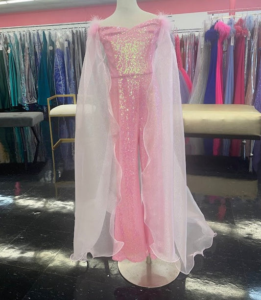 Marc Defang 8099K is a KIDS long pageant formal wear jumpsuit that is made of sequins and has off the shoulder straps.  The straps are attached to a cape with feathers at the shoulders.  Wow the crowd at your next pageant.  Available colors: Pink  Available sizes:  8