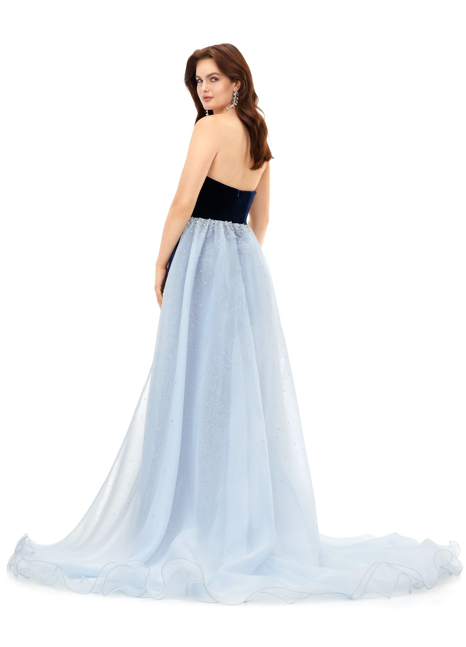 Ashley Lauren 11311 This stunning velvet gown features a sweetheart neckline with an organza overskirt. The overskirt is embellished with scattered crystals that cascade down the skirt. Strapless Bustier Crystal Details Stretch Velvet Organza Overskirt COLORS: Navy/Sky, Black/Ivory