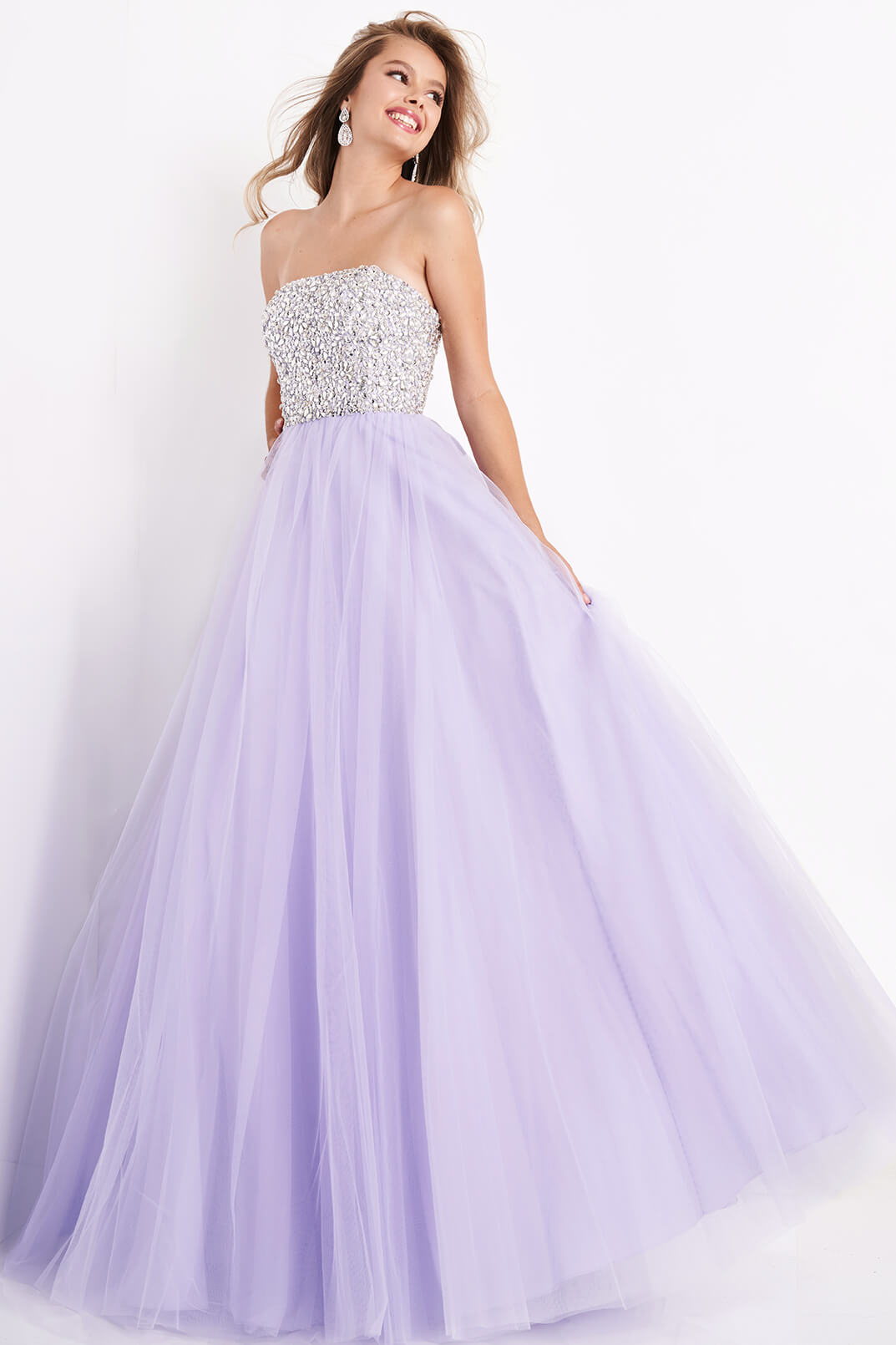 Jovani 52131 crystal embellished bodice strapless straight neckline tulle full long tulle skirt prom dress pageant gown evening dress JVN 52131 Exude elegance and grace with the Jovani 52131 Strapless Crystal Tulle A Line Pageant Dress. Featuring sparkling crystals and delicate tulle, this stunning gown is the perfect choice for any formal event. The A-line silhouette flatters all body types, while the strapless design adds a touch of glamour. Make a statement and shine like a star in this Jovani gown.