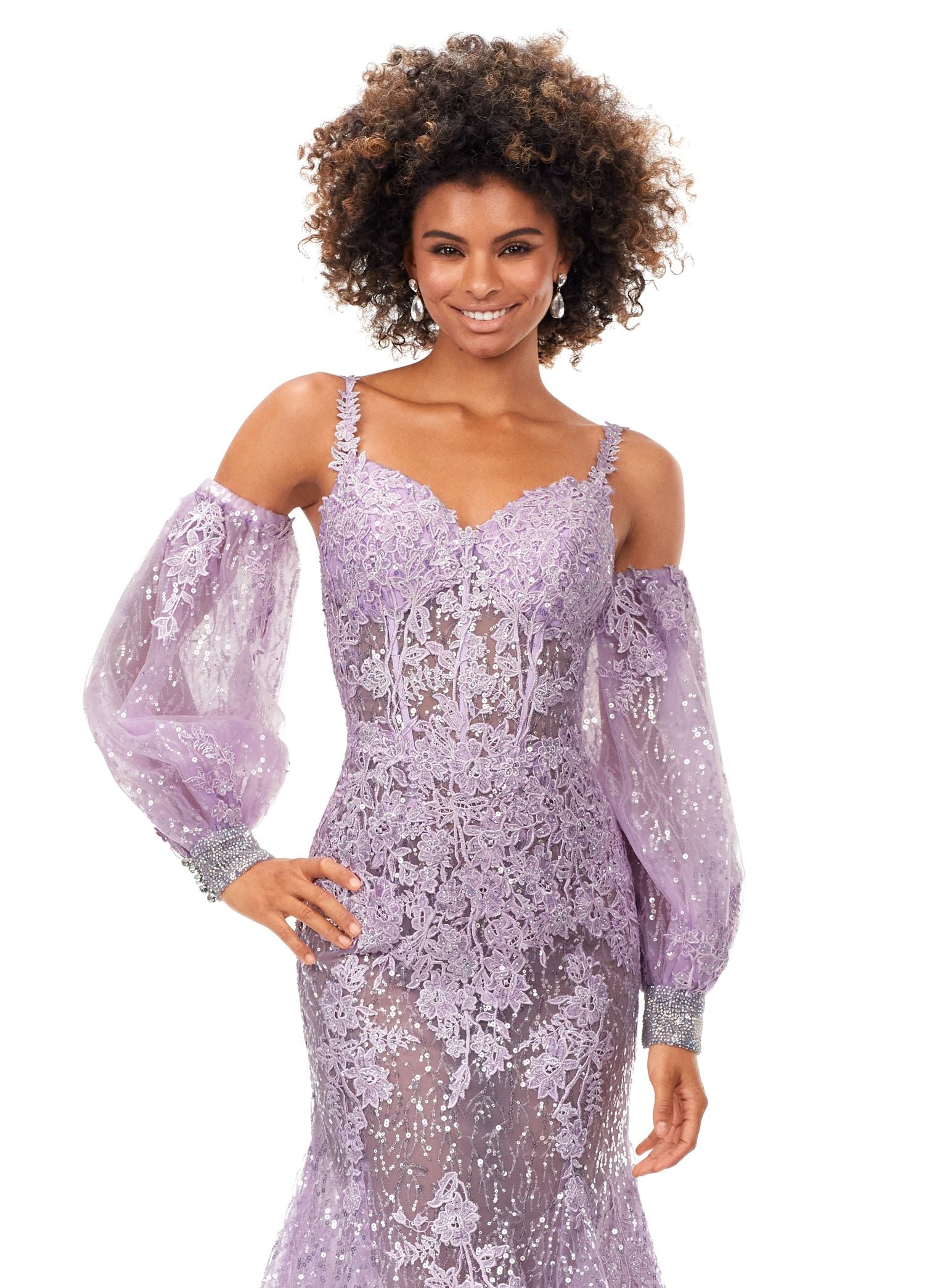 Ashley Lauren 11335 This stunning spaghetti strap sequin applique gown with appliques features an illusion corset bodice. The look is complete with a trumpet skirt and detachable puff sleeves. Spaghetti Straps Open Back Detachable Puff Sleeves Sequin Applique COLORS: Lilac, Sky