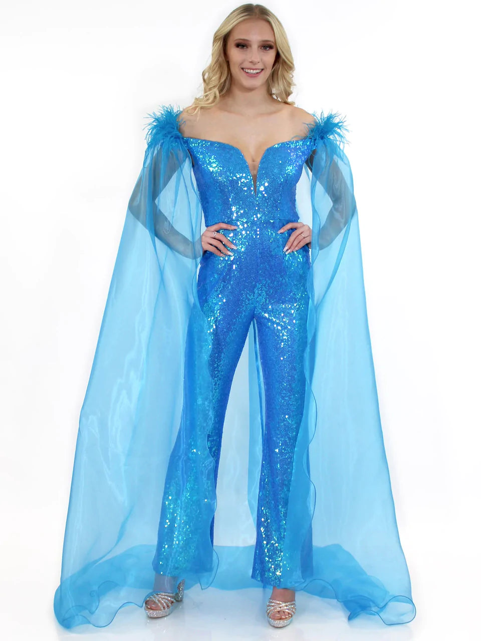 Mark-Defang-8099-Pageant-Jumpsuit-sequin-off-the-shoulder-cape-feathersMarc Defang 8099 This is a long pageant formal wear jumpsuit that is made of sequins and has off the shoulder straps.  The straps are attached to a cape with feathers at the shoulders.  Wow the crowd at your next pageant.  Available colors:  Pink, Turquoise, White, Black, Royal  Available sizes:  00, 0, 2, 4, 6, 8, 10, 12, 14, 16   