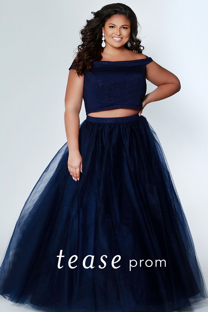 TE1909  Be a trend setter at Prom wearing a monochrome two-piece plus size dress. Sparkly red or blue off-shoulder top and tulle skirt with curly horsehair hem. Crop-top and waistband in matching light-red sparkle-embedded fabric. This dress is right on trend for prom.