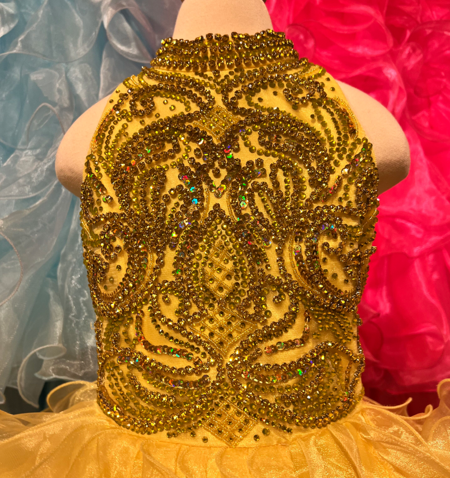 The elegant and sophisticated Sugar Kayne C328 Girls Preteens Pageant Dress boasts a dazzling halter neckline and full ruffle ball gown skirt with a crystal bodice, perfect for making a memorable fashion statement.  Colors: Barbie Pink, Cinderella Blue, Yellow