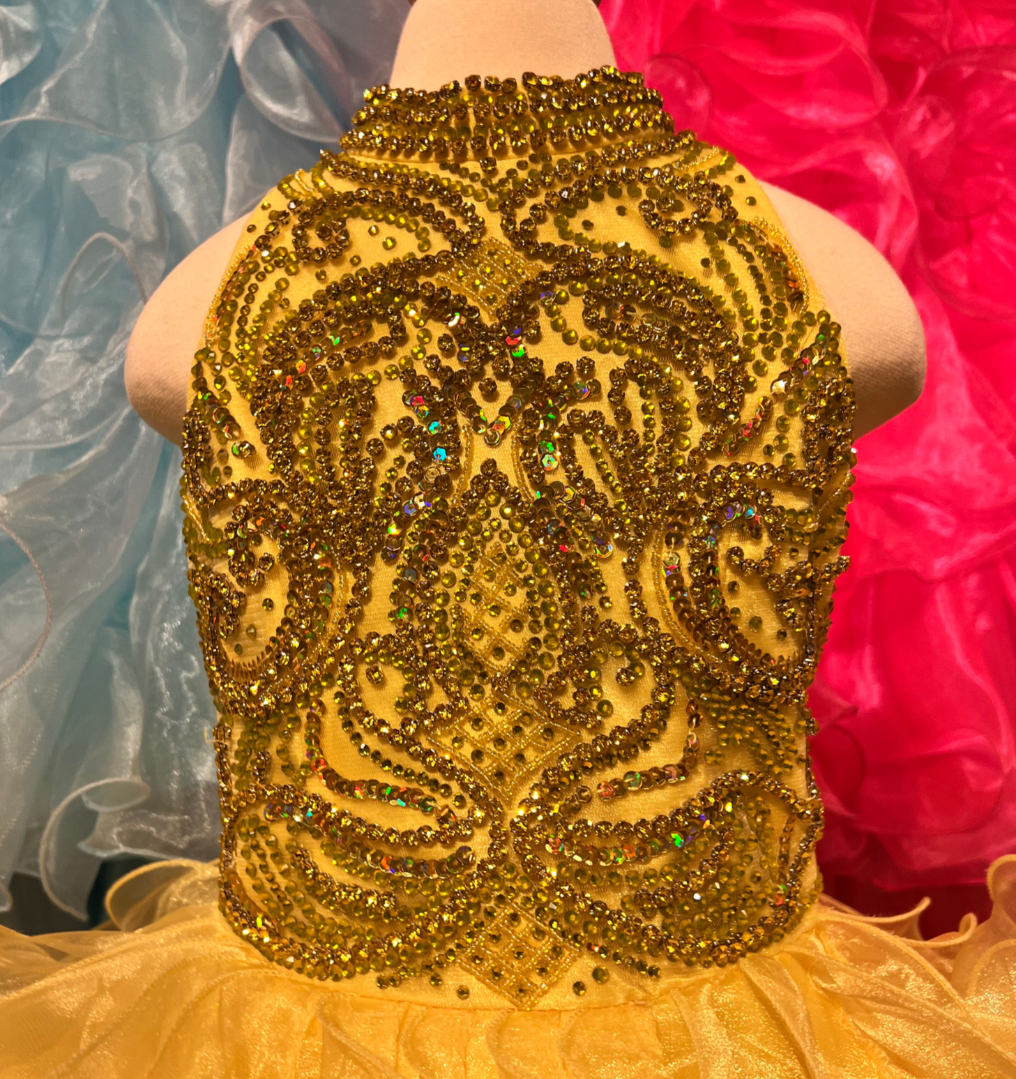 The elegant and sophisticated Sugar Kayne C328 Girls Preteens Pageant Dress boasts a dazzling halter neckline and full ruffle ball gown skirt with a crystal bodice, perfect for making a memorable fashion statement.  Colors: Barbie Pink, Cinderella Blue, Yellow