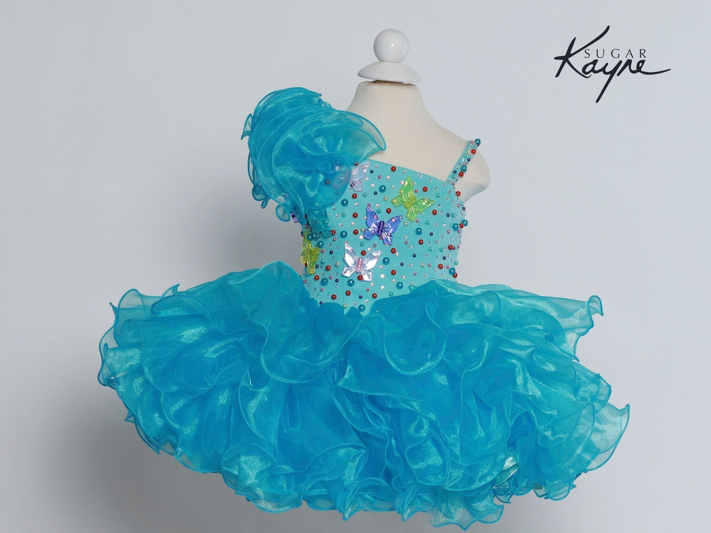 Sugar Kayne C209 Short Cupcake Ruffle One Shoulder Girls Pageant Dress Butterflies Great for any age! Corset Back  Sizes: 0M, 6M, 12M, 18M, 24M, 2T, 3T, 4T, 5T, 6T  Colors: White/Multi, Yellow/Multi, Aqua/Multi