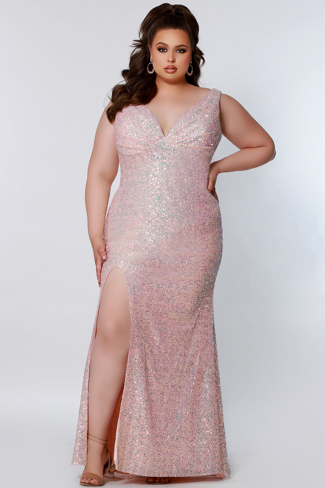 Tease Prom TE2201 Sydneys Closet Long Fitted Sequin Plus size prom dress slit  Colors: Aqua, Peach, Unicorn Size Availability: 14-28 Fitted silhouette V-neckline Pleated bodice Empire waistline Slit on right side of skirt 5 inch sweep train Bra-friendly straps Invisible zipper Scoop back Multi-dimensional sequins Stretch knit lining