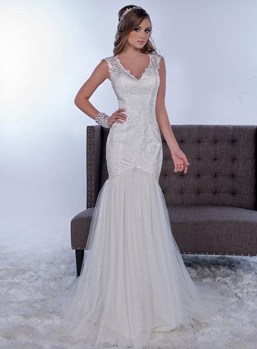 Adagio Bridal by Karishma Creations W 9268 is a stunning lace fitted bodice with a scallop lace V neckline with a sheer lace embellished back. Fitted Mermaid Silhouette with a soft trumpet tulle skirt. Petite sequins allow the lace to glisten. Sheer lace cap sleeve. Sweeping train.  Size 8  Color Ivory