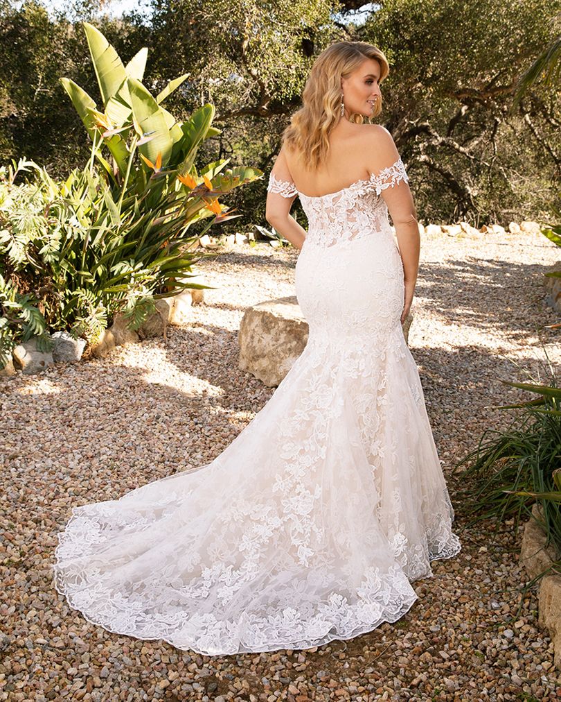 Style 2376 KARINA by Casablanca Bridal is a glamorous twist on the classic lace wedding dress. Off-shoulder sleeves transition into a classic sweetheart neckline, while floral lace swirls all throughout the fit-and-flare silhouette. The illusion back, lined with a row of subtle crystal buttons, transitions flawlessly into a gently scalloped train. A matching, two-tier cathedral length veil is available for the bride who wants to make an extra remarkable impact.  Size: 10, 14, 20  Ivory/Nude/Ivory/Silver