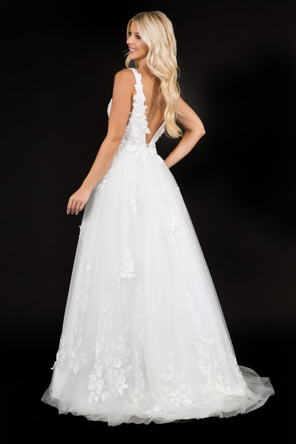 Nina Canacci 1495 is a long 3d Floral Applique embellished Deep V Neck Prom Dress. This Romantic formal gown features embellished floral appliques cascading into the tulle A Line Ballgown Skirt. Great Formal dress.  Available Sizes: 0-10  Available Colors: Ice Blue, Ivory