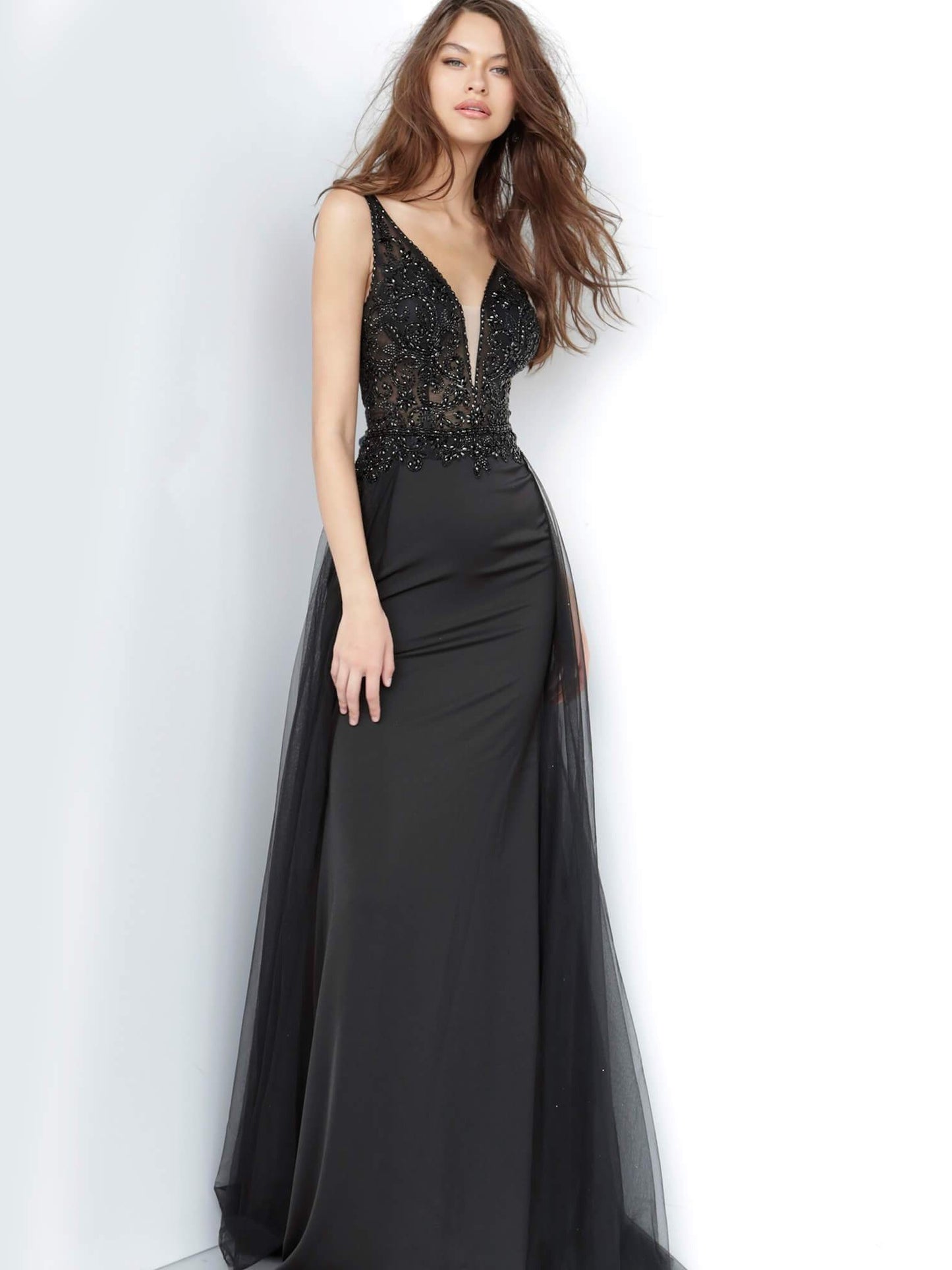 JVN 02253 is a long fitted Prom Dress with a sheer Embellished bodice with a Deep V Plunging Neckline with a mesh insert. Features an open V Back. Fitted Skirt has a tulle overlay overskirt with embellishments cascading from the bodice to add a soft transition. Great pageant gown or Dress for any formal event!